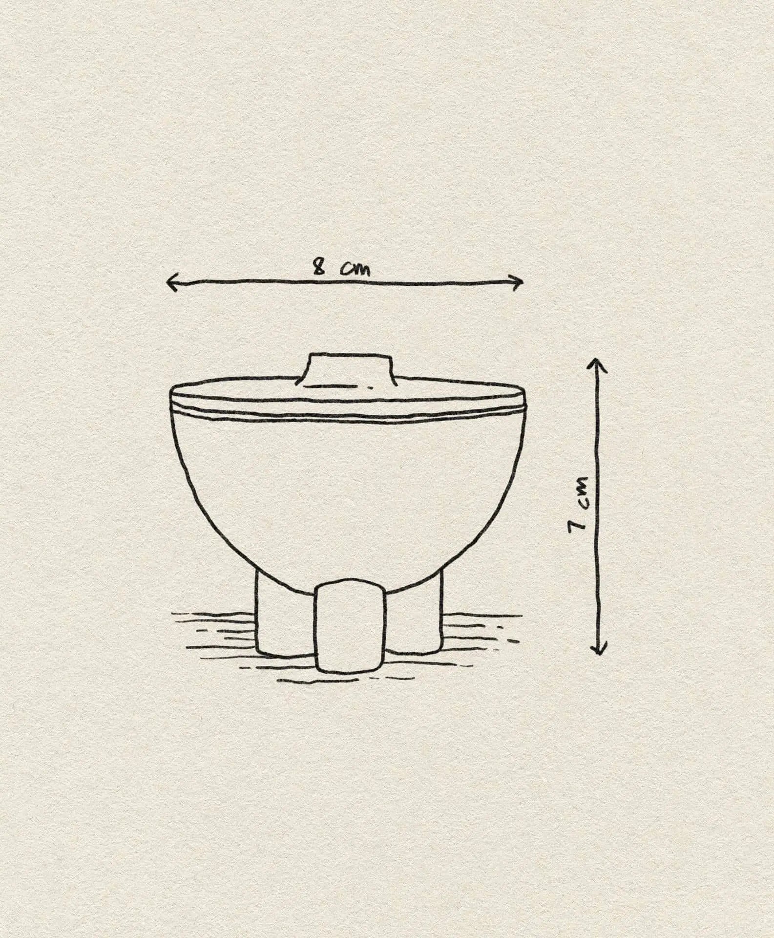A simple line drawing of the 101 Copenhagen Duck Jar, Mini by 101 Copenhagen, featuring a bowl with three short legs (8 cm wide, 7 cm tall) and dimension arrows. The background is a light beige textured surface.