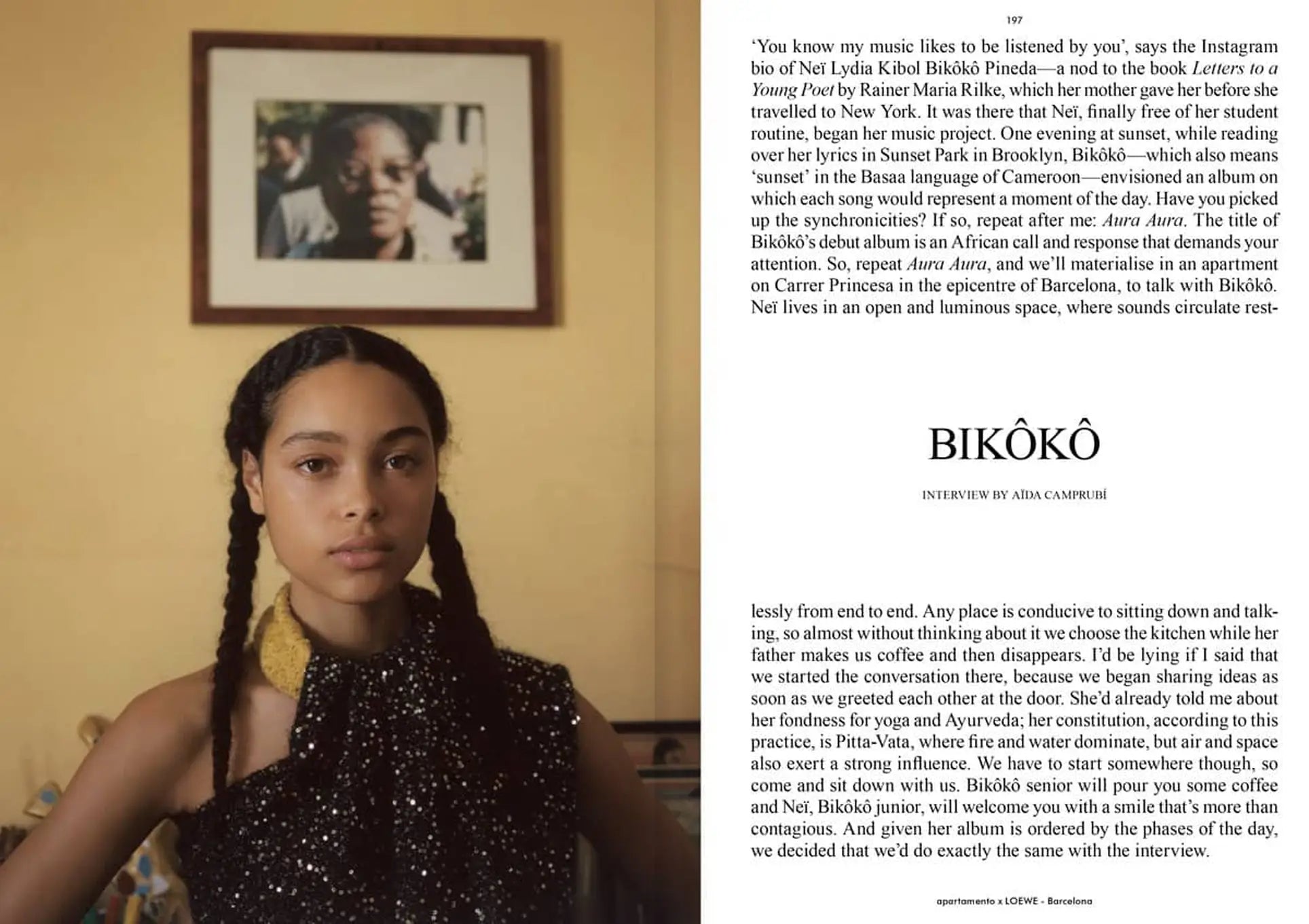 A young woman with long, dark braids in a sleeveless brown top sits by a wall with a framed portrait, featured in Apartamento Magazine Issue #28 with an interview and text about her music journey.