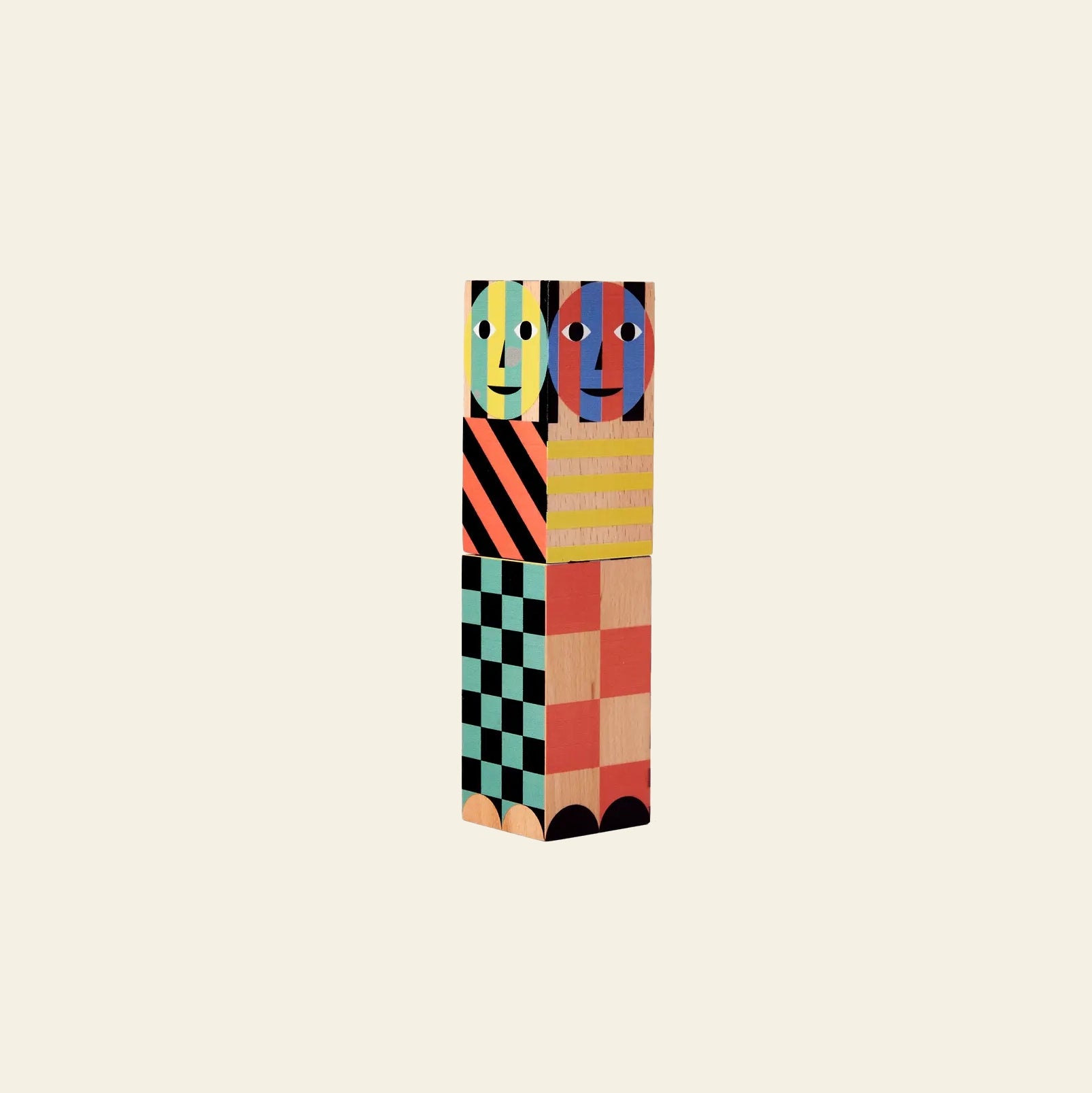 The Areaware Everybody Grinder by Areaware features a vertical stack of colorful wooden blocks with abstract faces on top and geometric patterns below, inspired by the playful flavors and spices of a well-stocked kitchen drawer.