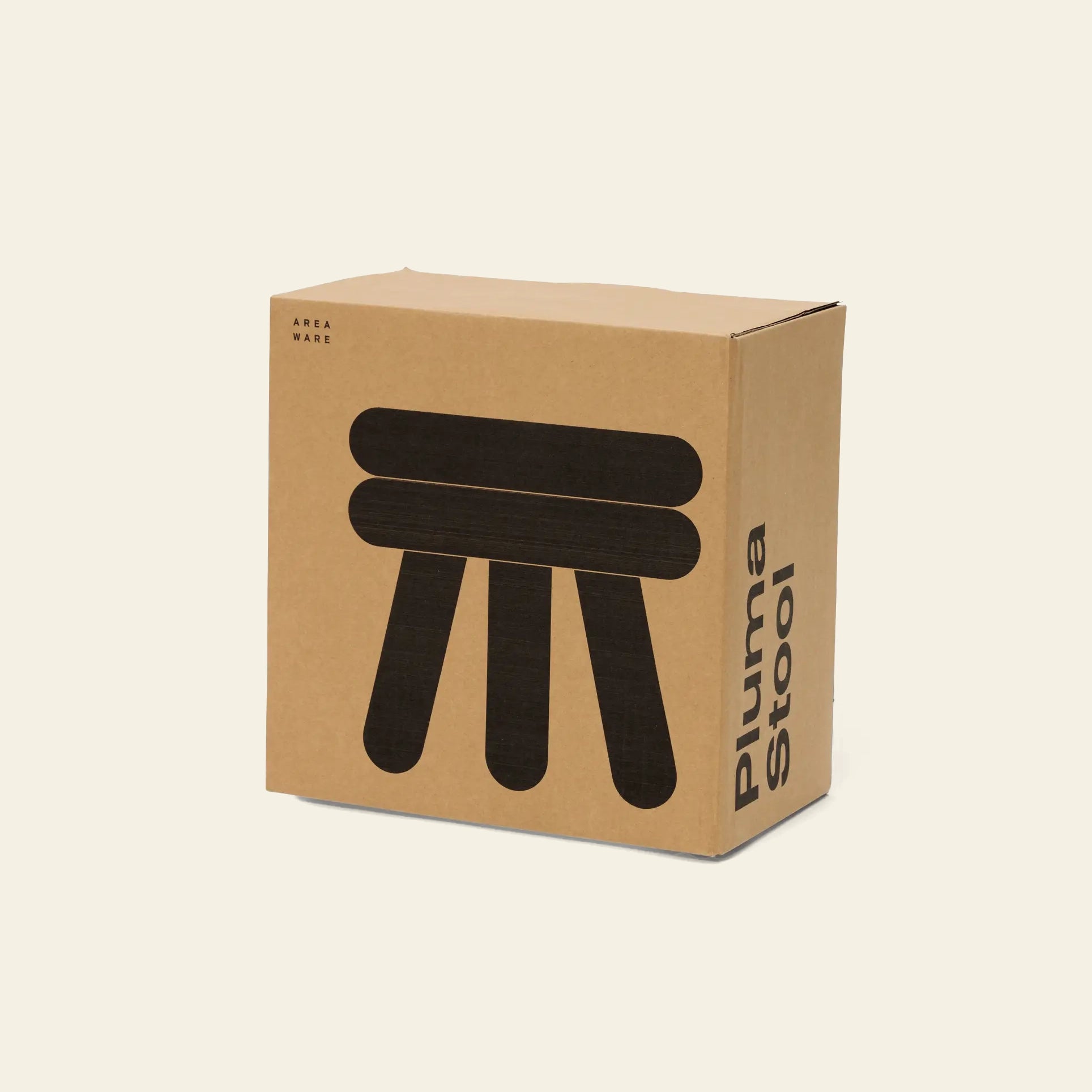 A cardboard box on a light background displays a minimalist black graphic of the three-legged Areaware Pluma Stool Short and the “Areaware” brand, emphasizing its modern design and versatile function.