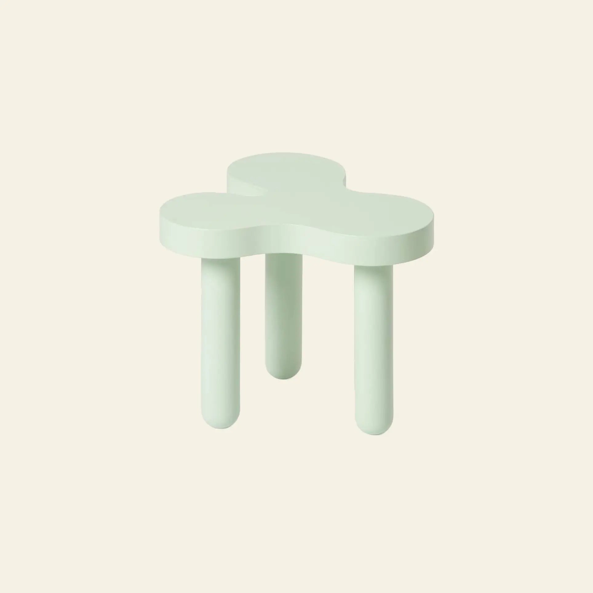 The Areaware Splat Side Table Short by Areaware features a clover-shaped light green seat and three rounded legs, set against an off-white background, evoking a playful and distinctive design.