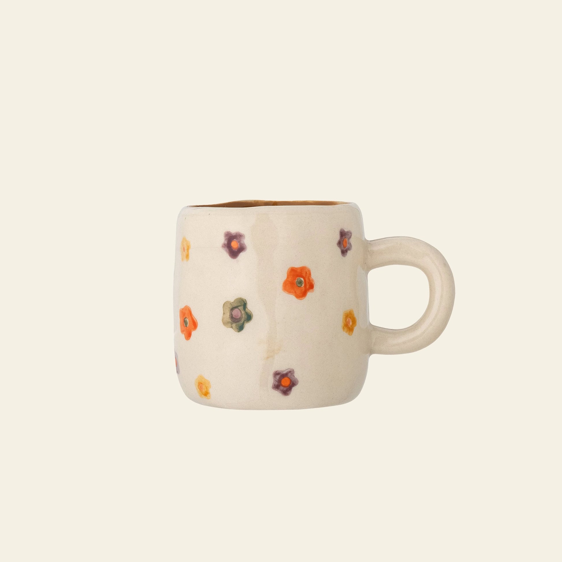The Bloomingville Addy Cup by Bloomingville is a cream-colored stoneware cup with a round handle, featuring small hand-painted floral details in orange, red, and green on a plain light background.