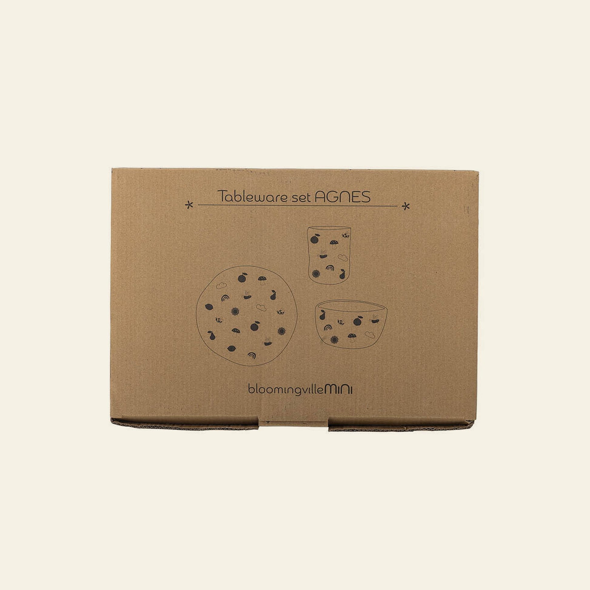 A brown cardboard box labeled Bloomingville Agnes Tableware Set features simple black illustrations of three polka dot tableware pieces, with the Bloomingville brand printed at the bottom.