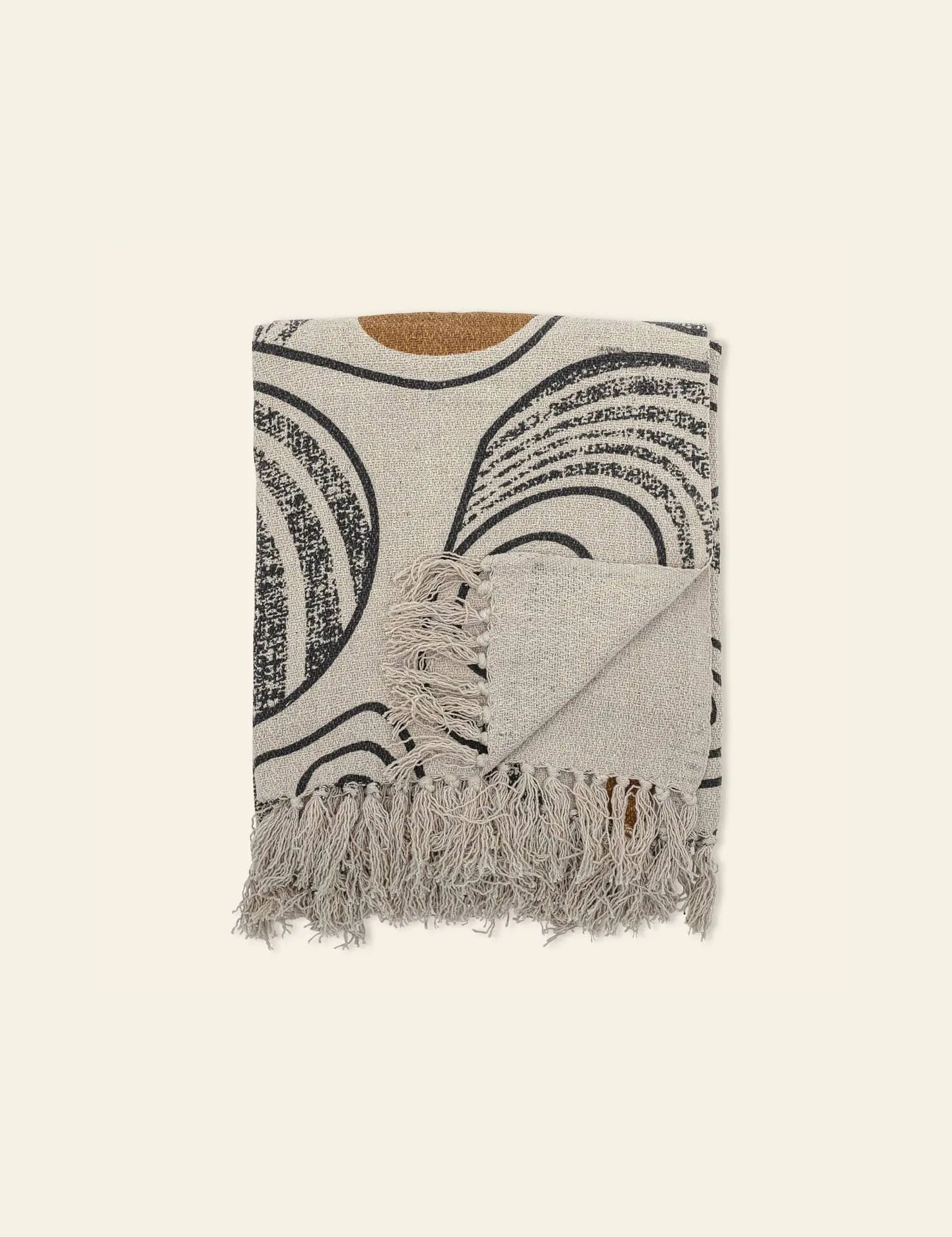 The Bloomingville Giano Throw by Bloomingville, made from recycled cotton, showcases black and brown abstract curved lines with fringed edges. Displayed on a light background, it brings stylish warmth and cosy vibes to any space.