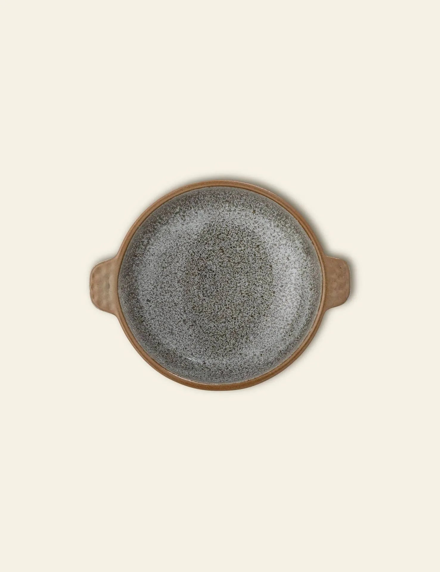 The Bloomingville Hariet Bowl by Bloomingville is a round, speckled gray stoneware bowl with two small opposite handles, shown from above on a plain light beige background.