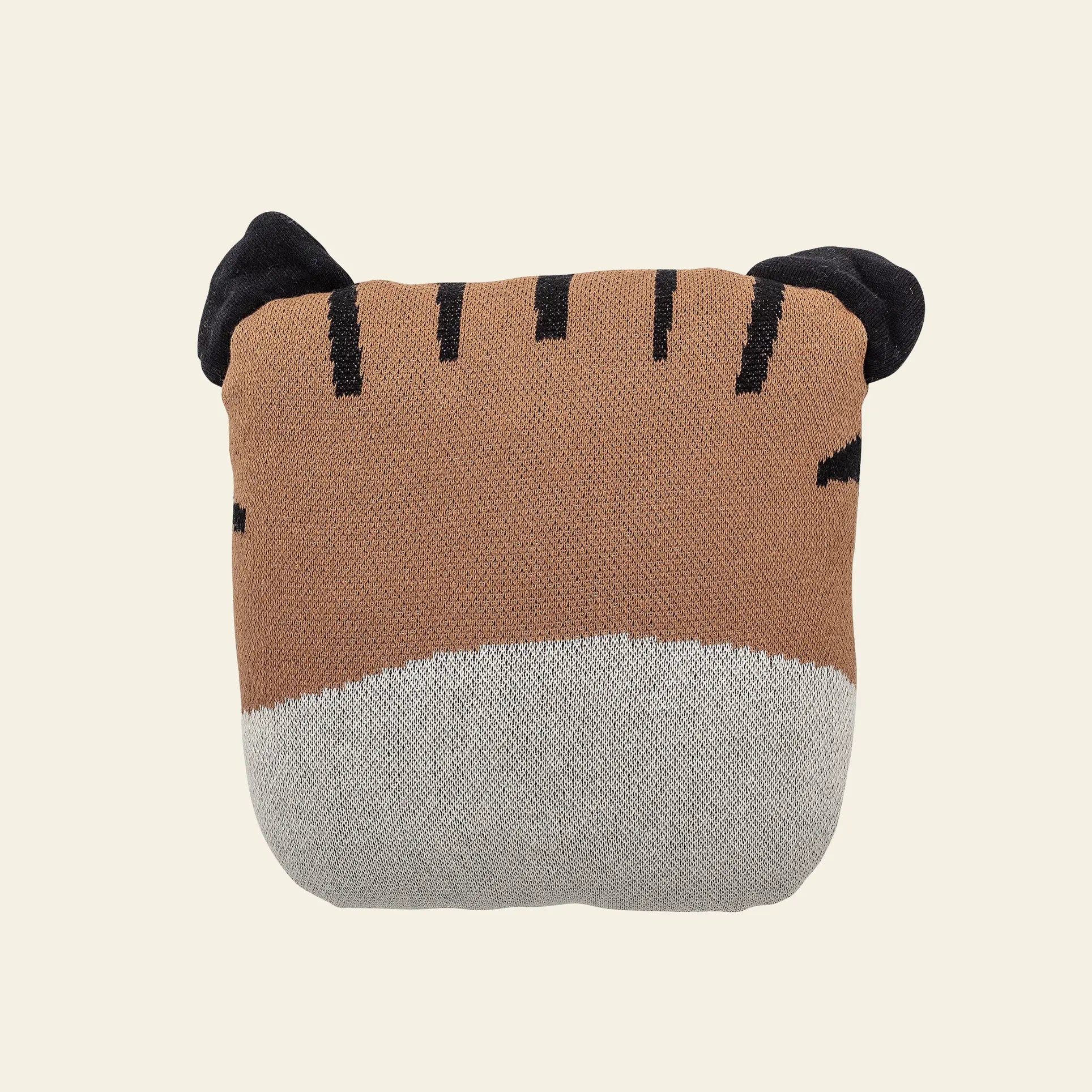 The Bloomingville Muzamel Cushion is a square-shaped soft toy designed as a tiger’s face, featuring brown and gray colors, black embroidered stripes, and two black ears—a playful accent against a plain light background.