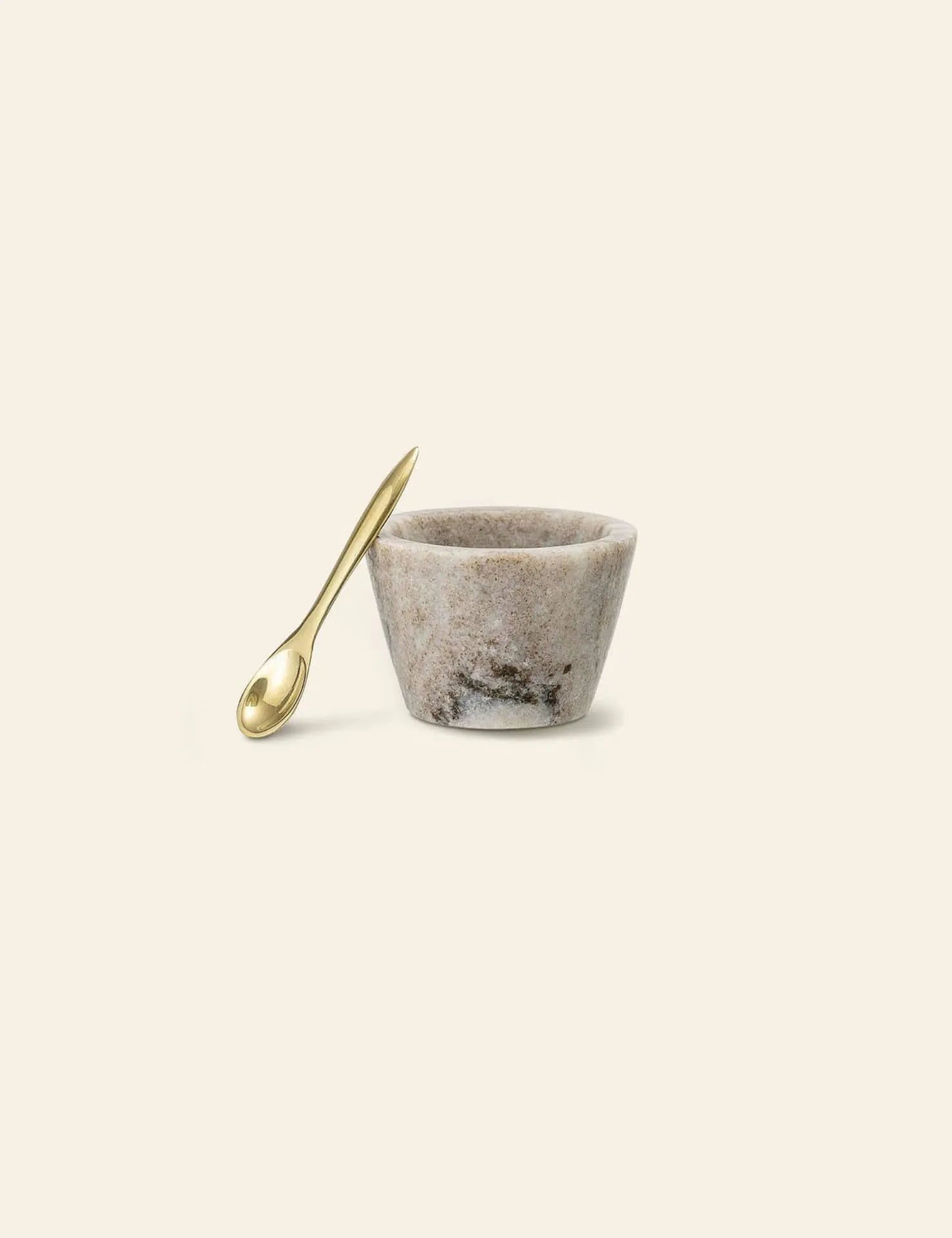 The Bloomingville Rosamynthe Salt Jar w/Spoon sits on a light background, its marbled texture and shiny gold spoon making it perfect for serving spices or as a stylish accent from Bloomingville.