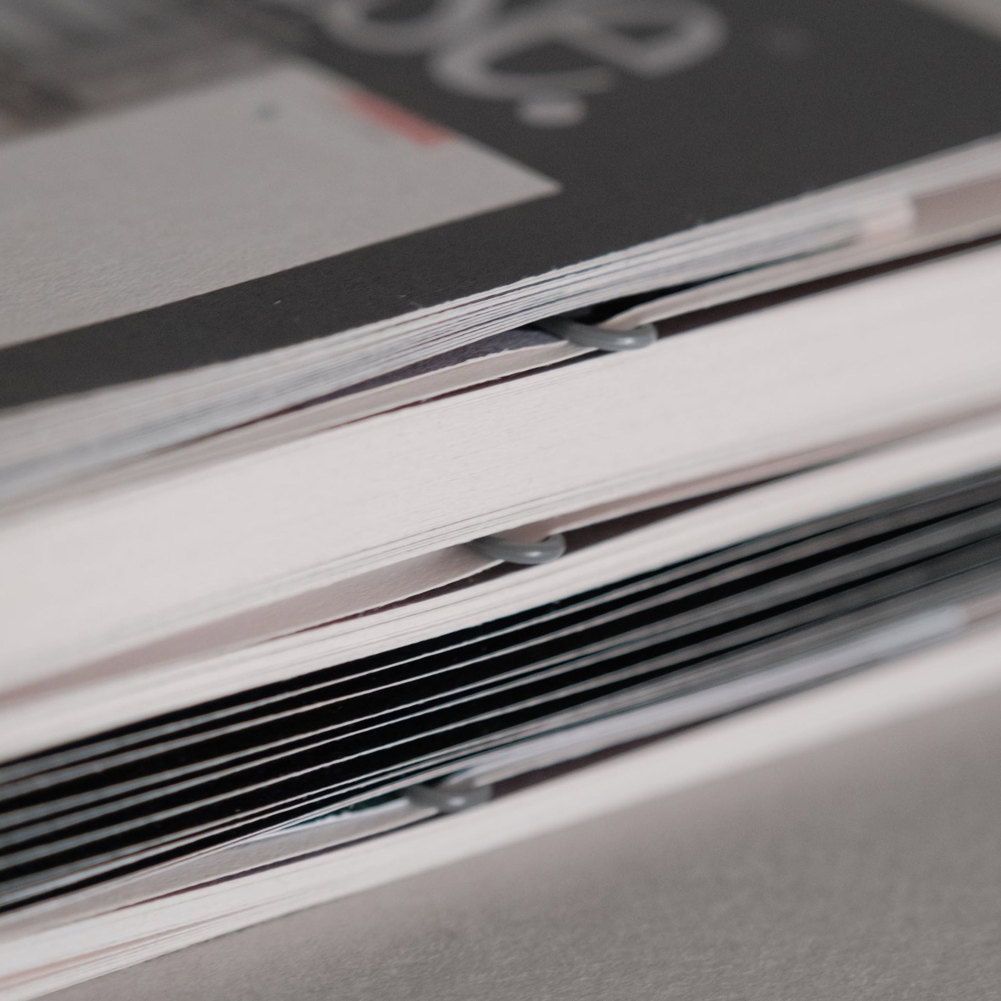 A close-up of two booklets spines bound with staples—perfect inspiration for upcycling, as featured in Bluetaped Refuse: A Dumpster Diving Craft Handbook by Wong Eng Geng from Bluetaped.