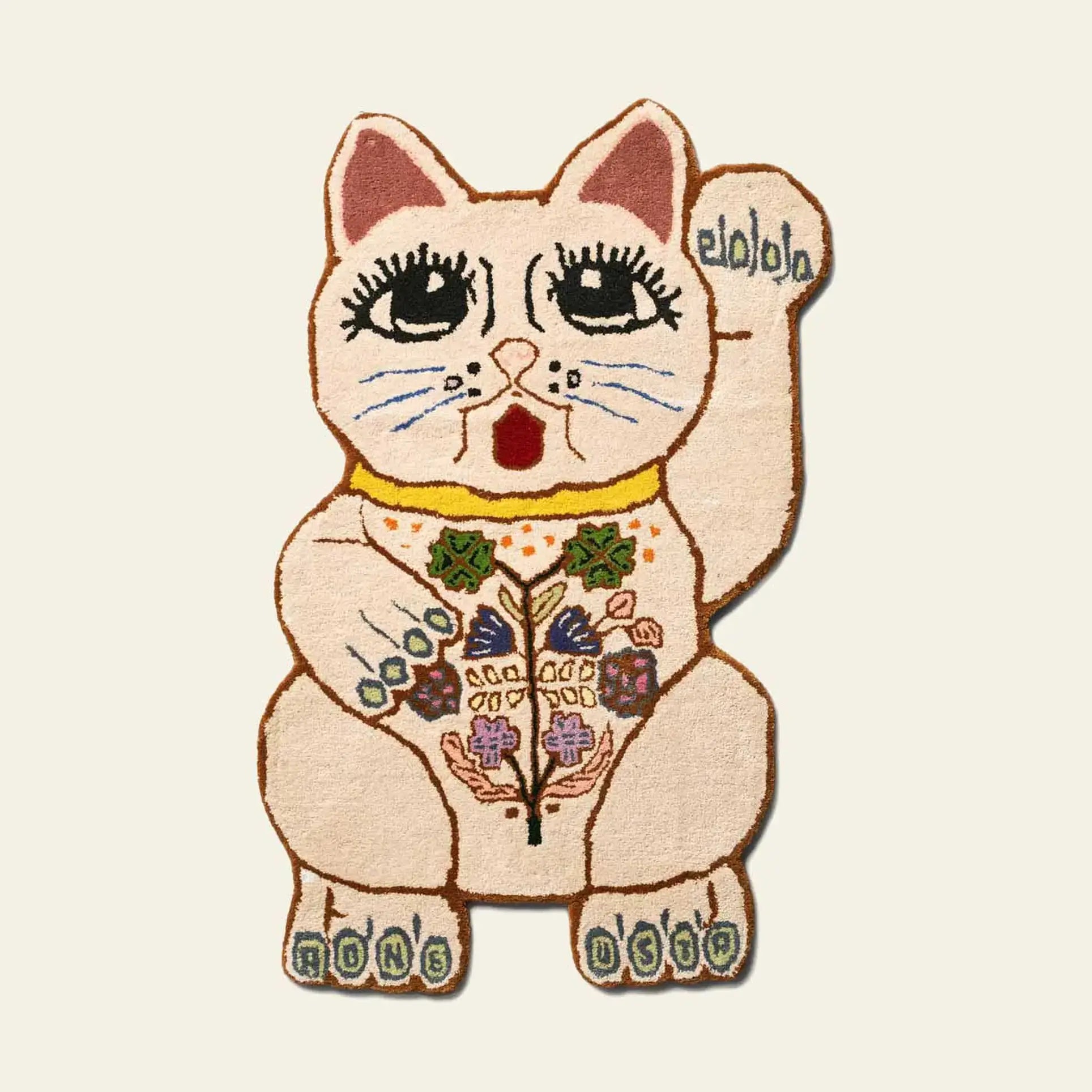 The Bongusta Lucky Rug by Bongusta is a hand-tufted wool rug shaped like a maneki-neko, with large eyes, raised paw, floral accents, and RING RING on its feet in soft pastels over a cream background.