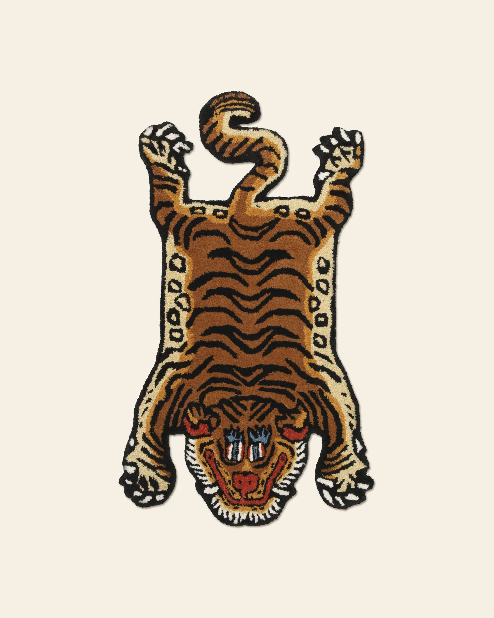 The Bongusta Tiger Rug, Baby by Bongusta features black stripes, white accents, and a stylized face. Shaped like a traditional Tibetan tiger rug with spread-out legs, it brings a playful jungle vibe to any room.