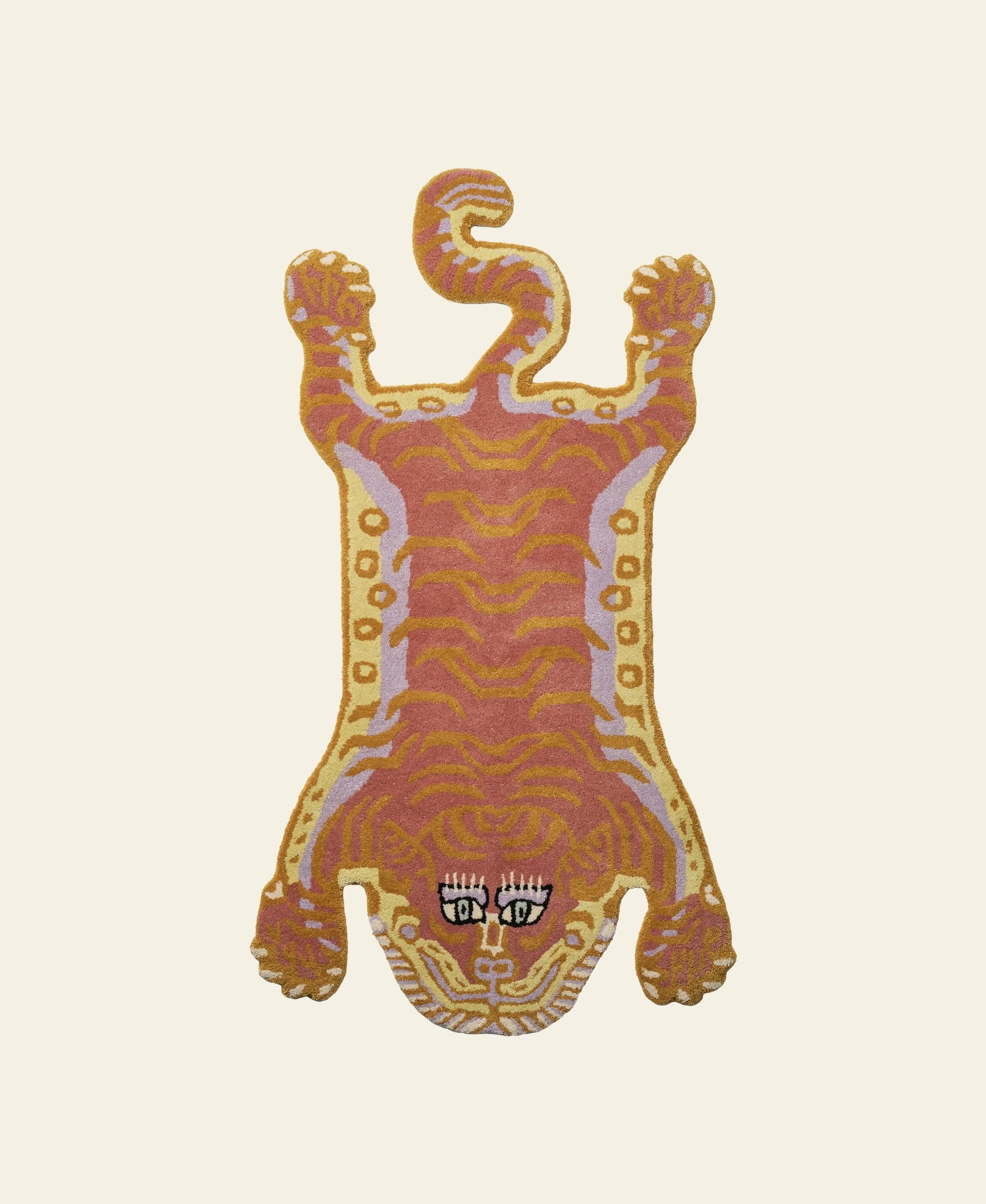 The Bongusta Tigress Rug, Small features a stylized tiger motif with orange, yellow, and pink patterns, bold black and white eyes, and a detailed face from Bongusta, set on a plain cream background.