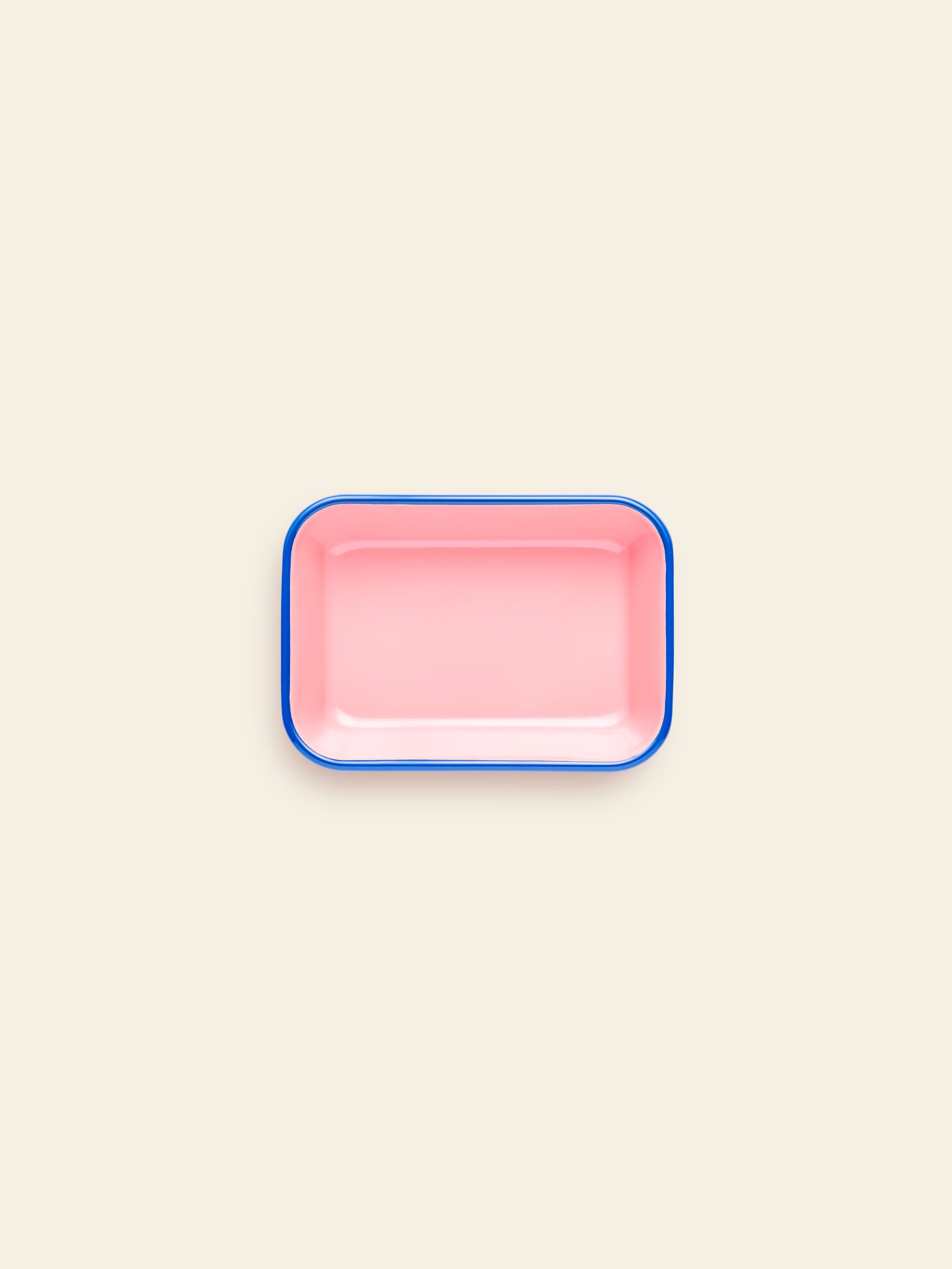 The Bornn Enamelware Colorama Baking Dish, Medium, by Bornn Enamelware, is a rectangular pink dish with a blue rim shown on a plain cream background.