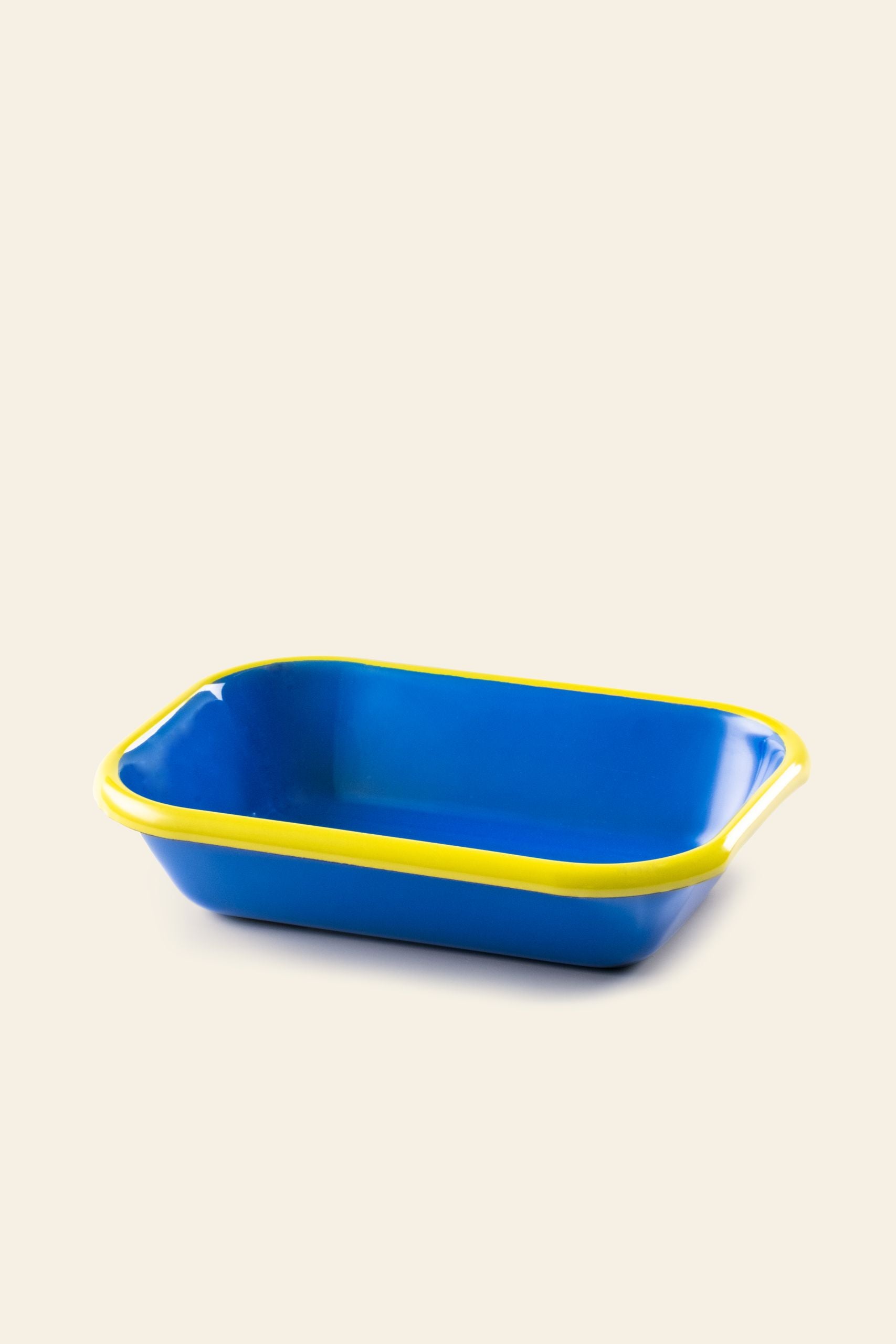 The Bornn Enamelware Colorama Baking Dish, Small by Bornn Enamelware features a blue rectangular shape with rounded corners and a yellow rim, displayed on a light beige background.