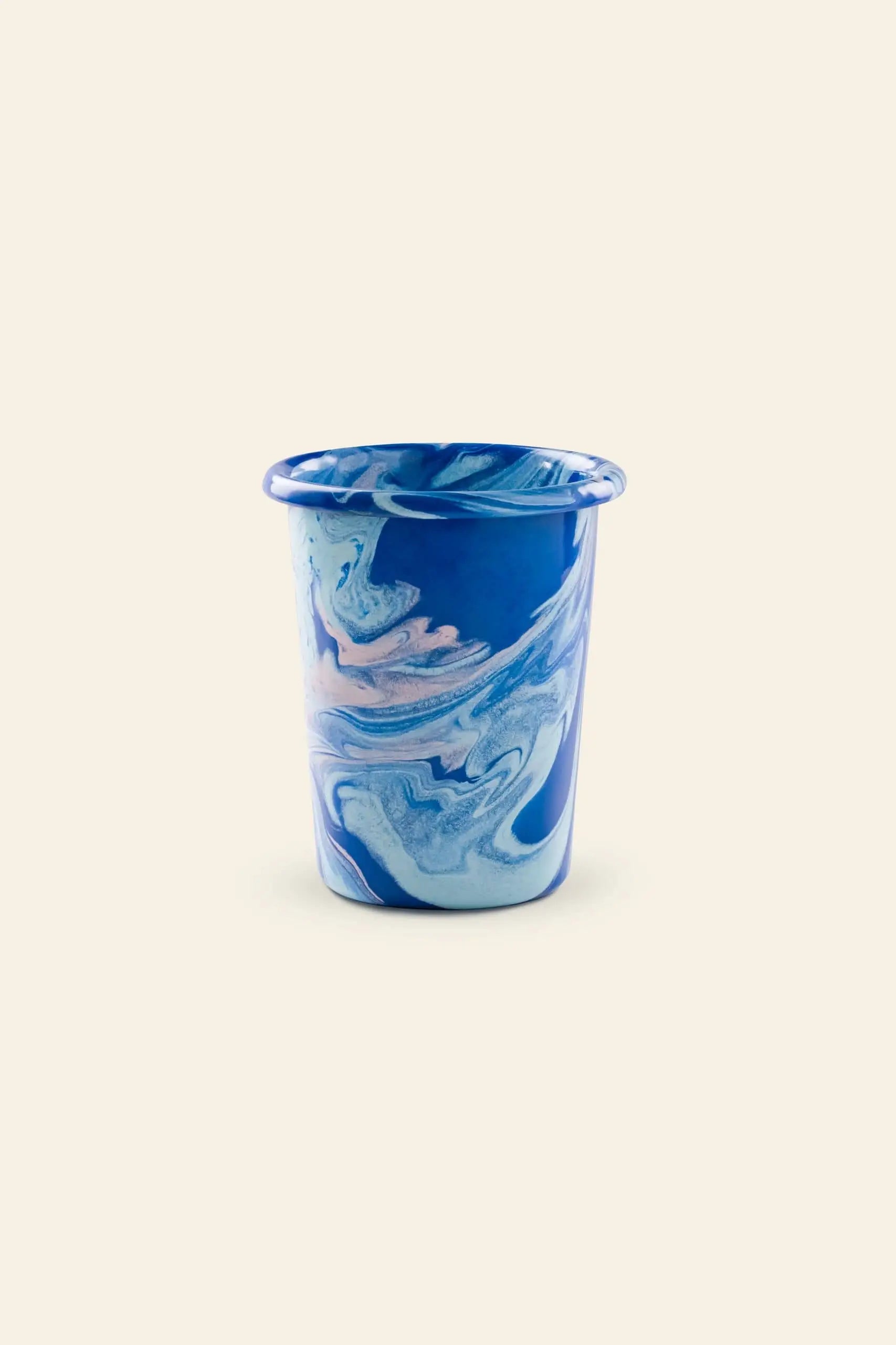 The Bornn Enamelware New Marble Tumbler Cup features a marbled blue, white, and pink swirl design, styled on a light beige background. Available at The Stacked Store.
