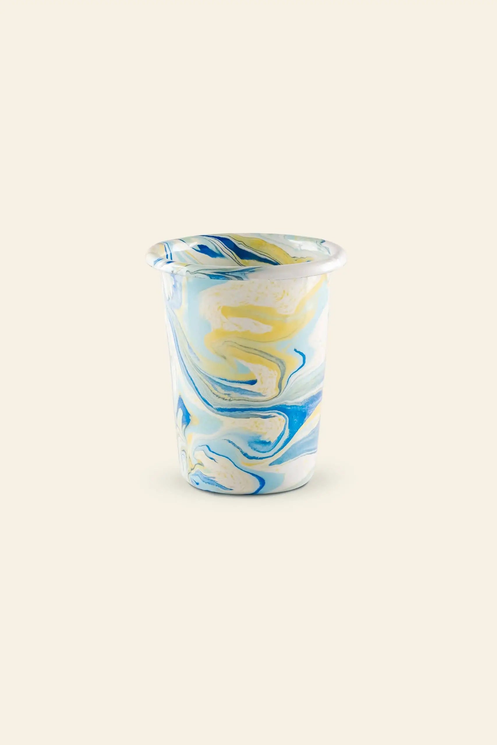The Bornn Enamelware New Marble Tumbler Cup features a blue, yellow, and white marbled pattern on beige. This small cylindrical cup with a rounded rim is available exclusively at The Stacked Store.