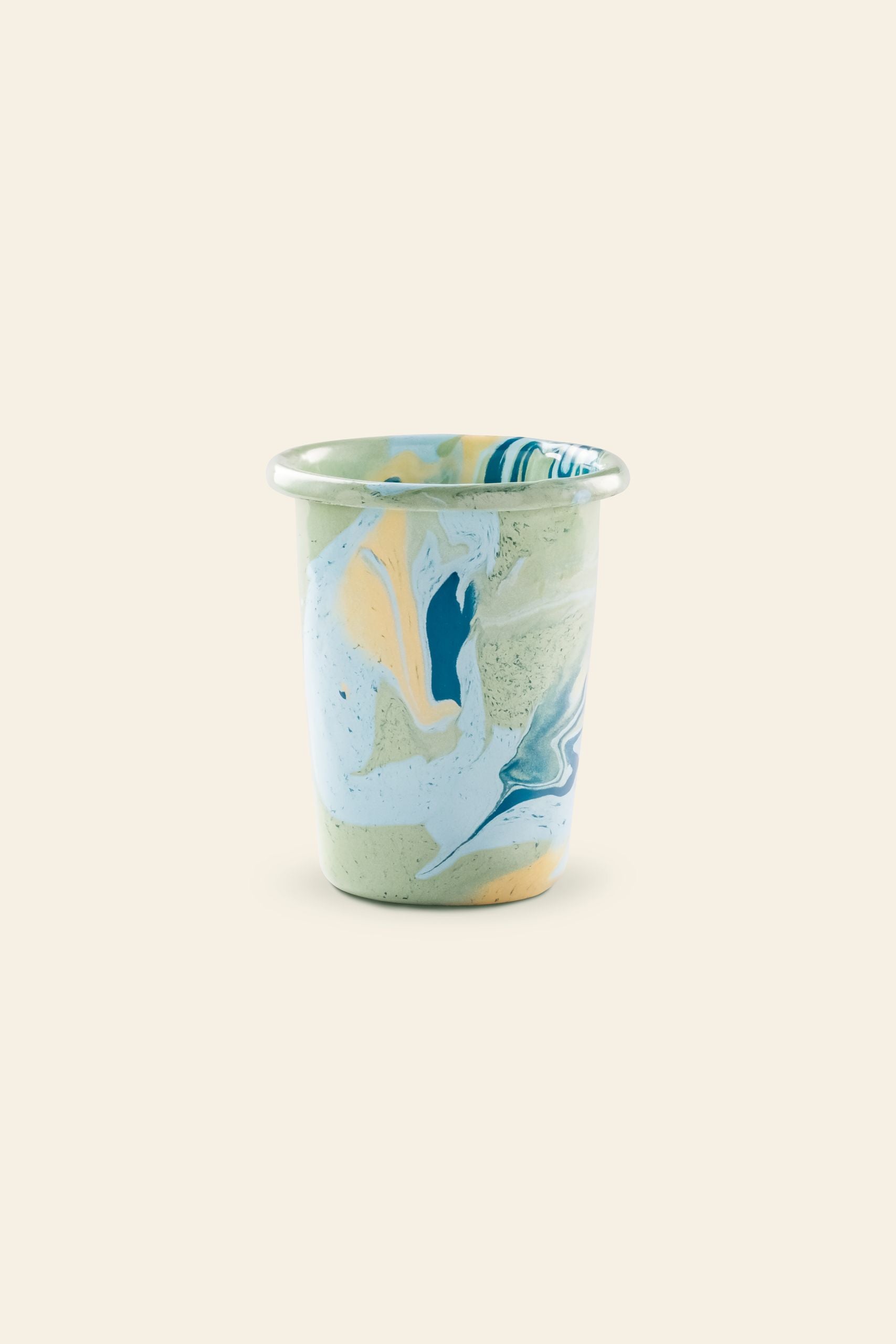 A small Bornn Enamelware New Marble Tumbler Cup in blue, yellow, and white marbled patterns with a light green base, shown on a plain beige background. Available at The Stacked Store.