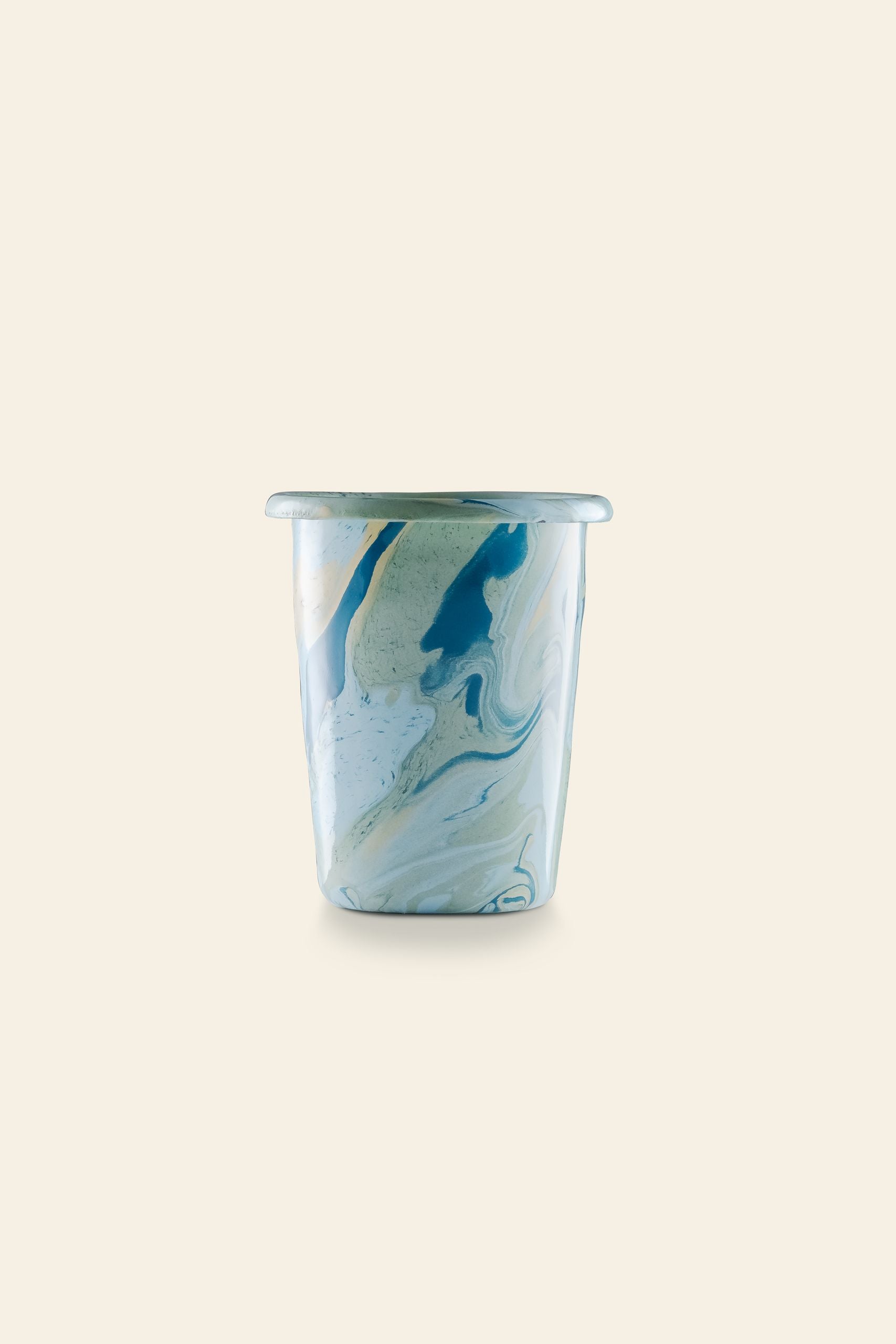 The Bornn Enamelware New Marble Tumbler Cup features a marbled blue, white, and tan design, shown against a beige background. Available at The Stacked Store.