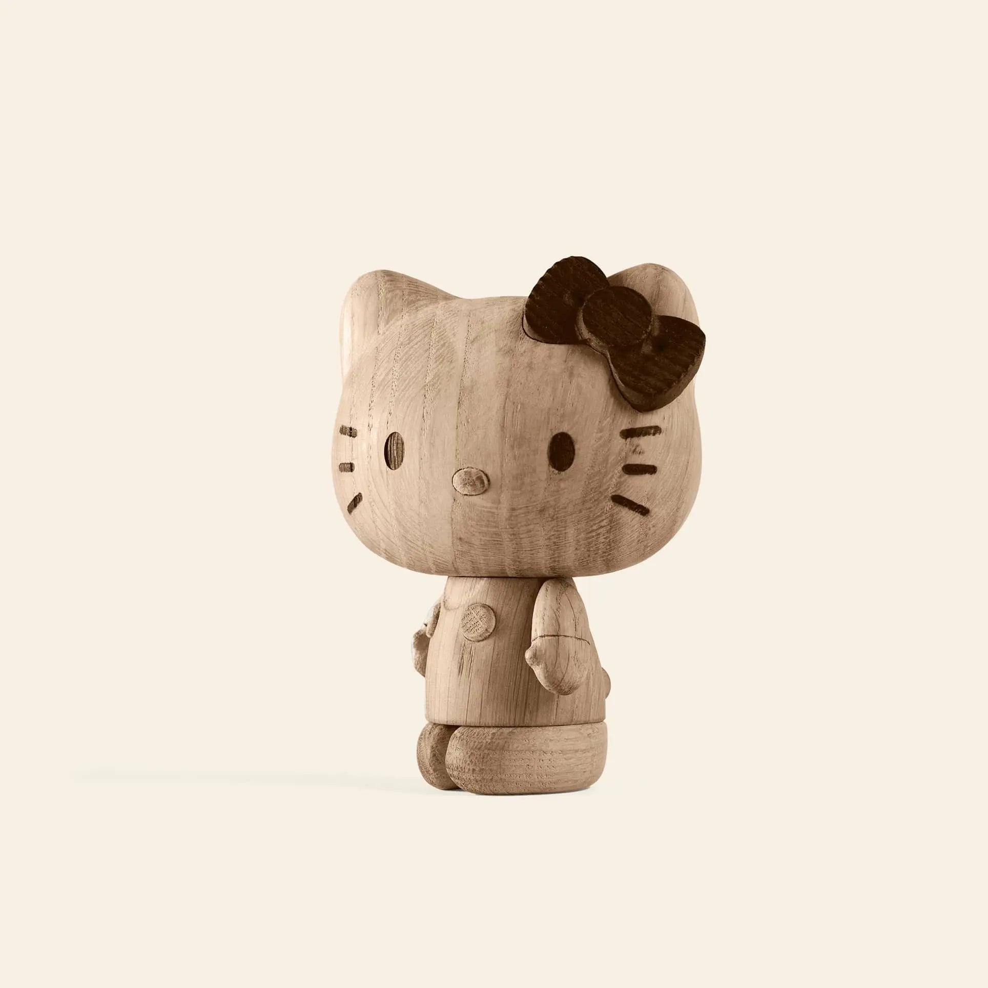 The Boyhood Hello Kitty Small by Boyhood is a wooden figurine featuring simple facial details and a dark bow on its left ear, set against a light background—a charming piece for any wooden collectibles collection.
