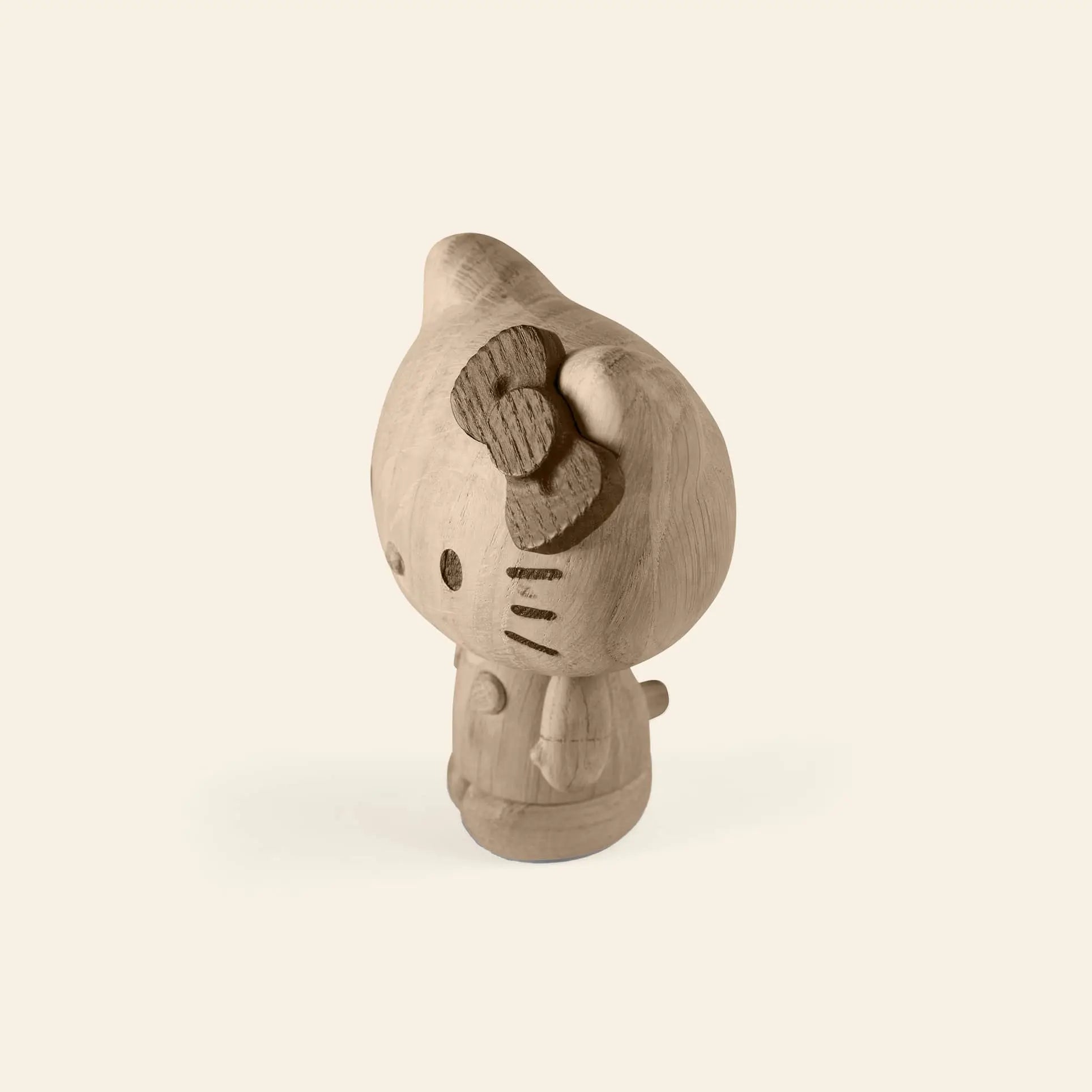 The Boyhood Hello Kitty Small by Boyhood is an unfinished wooden figurine with a bow, standing upright against a light background—ideal for fans of wooden collectibles or those fond of cherished childhood memories.