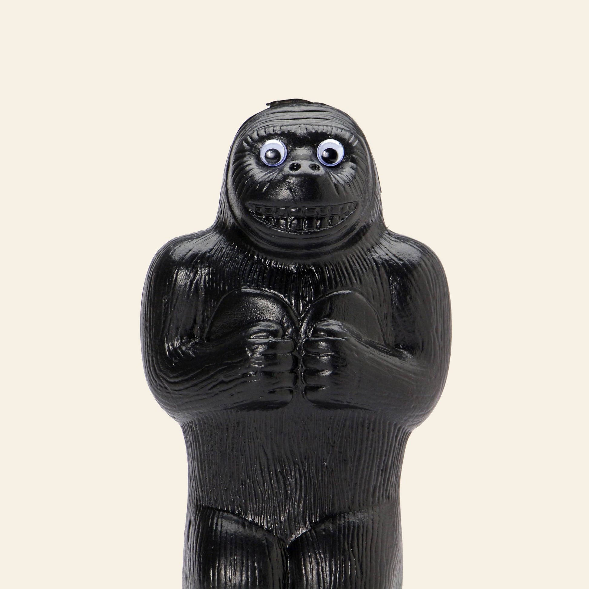 The DETAIL Gorilla Bank Small by DETAIL is a black, upright gorilla-shaped coin bank with exaggerated features, bulging googly eyes, and a wide grin—adding playful charm to any space.