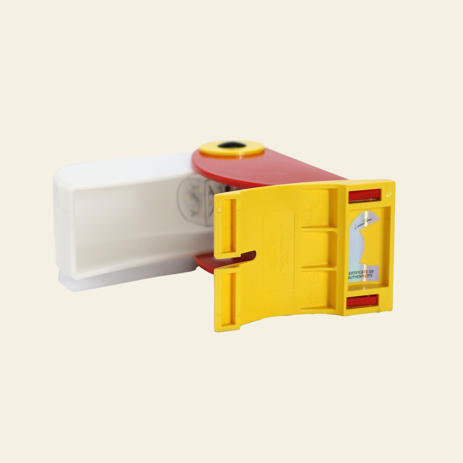 The DETAIL Toucan Lamp by DETAIL features a yellow, red, and white design with labeled instructions and a sliding mechanism, capturing vintage charm with its rounded details—an iconic lighting piece for any space.