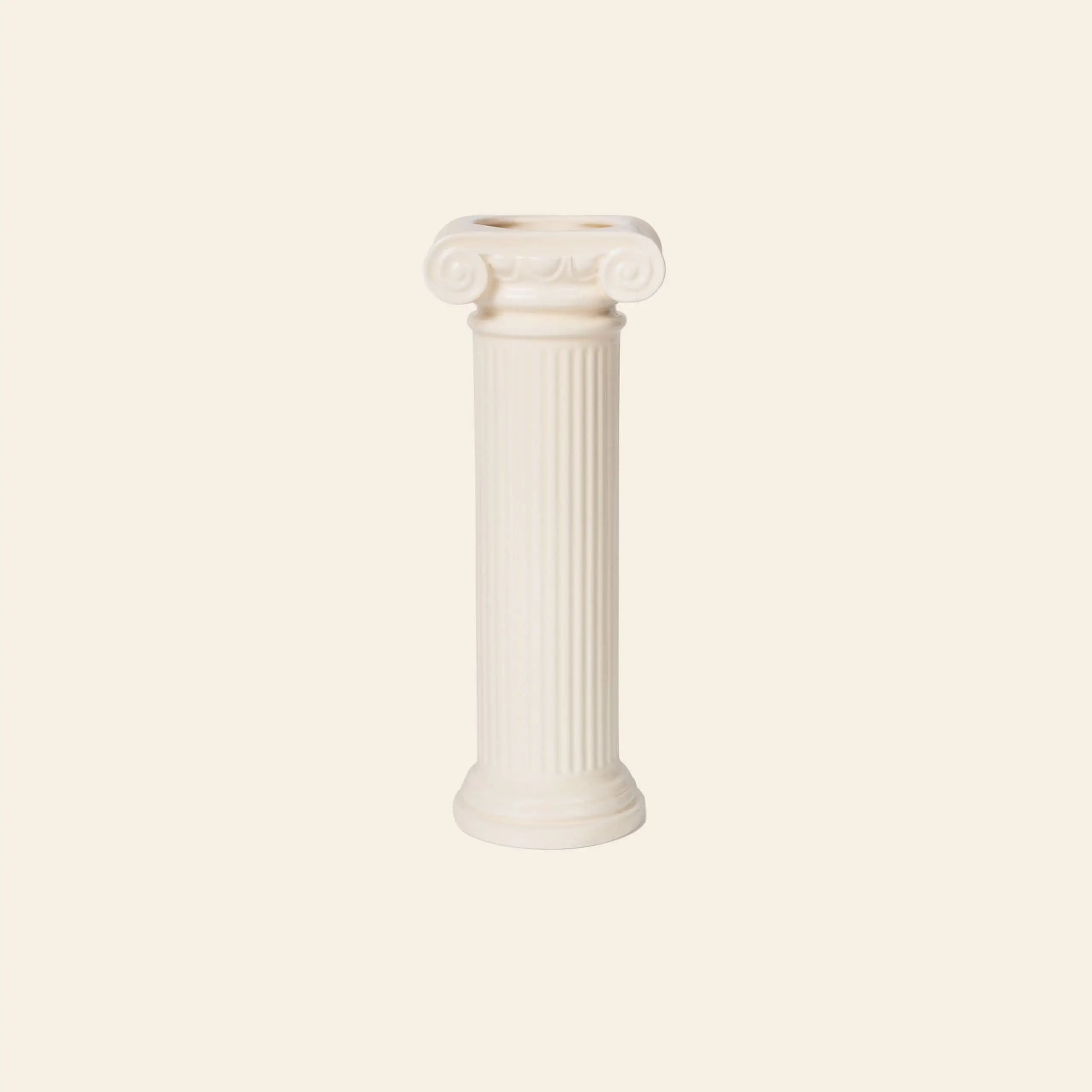 The DOIY Athena Vase by DOIY features a white, Greek-inspired Ionic column design with elegant scrolls at the top and a smooth base, standing upright against a light beige background.