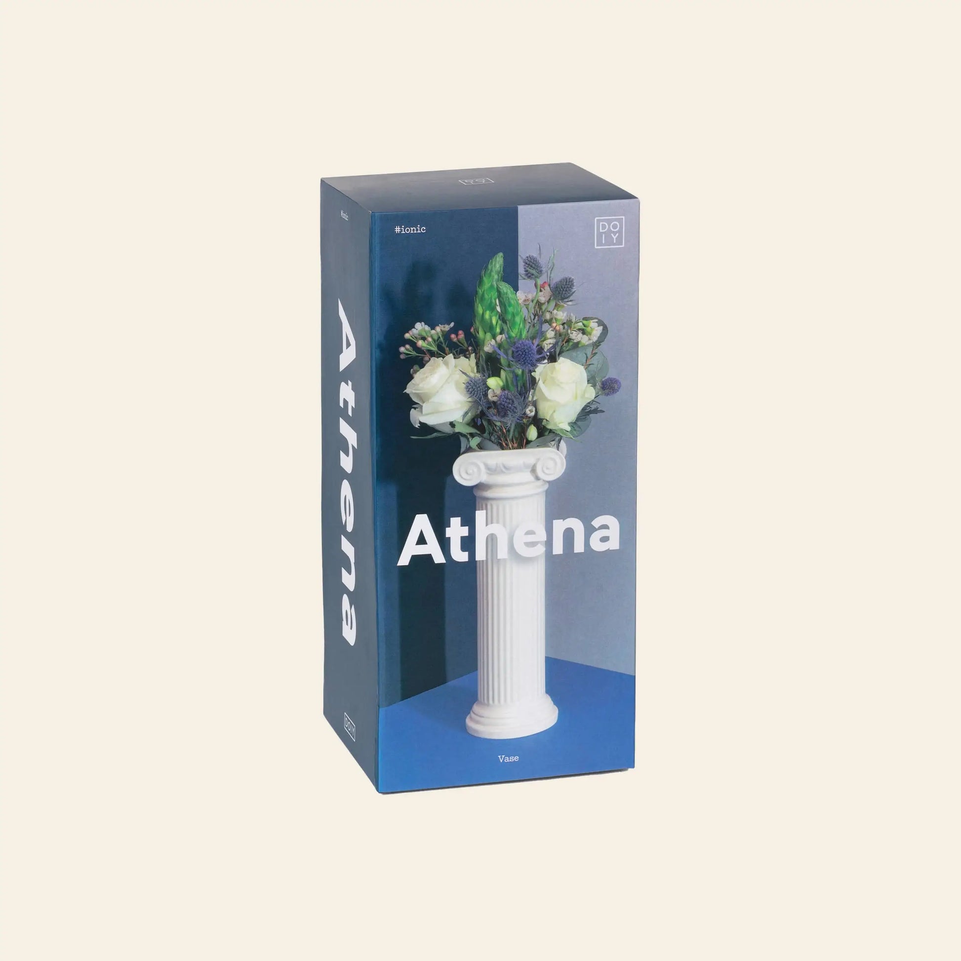 A box labeled “DOIY Athena Vase” from DOIY shows a white vase inspired by a Greek Ionic column, filled with white roses and greenery, set against a blue background.