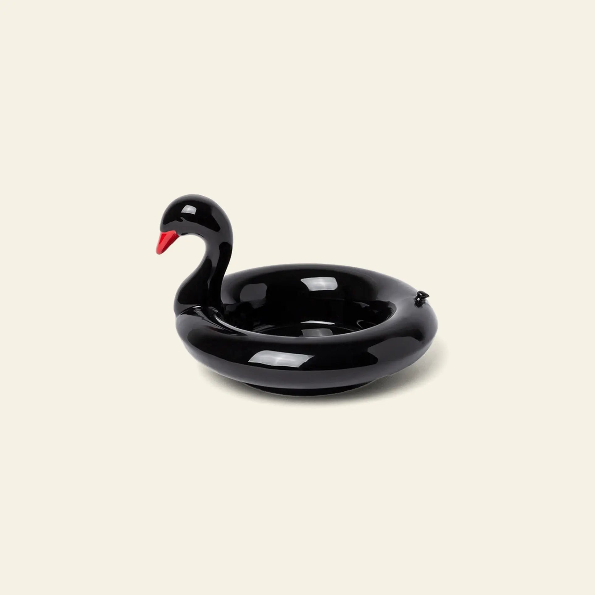 The DOIY Black Swan Floatie Bowl by DOIY, featuring a red beak, is displayed on a plain light background, making it a striking decorative accent for your next pool day.