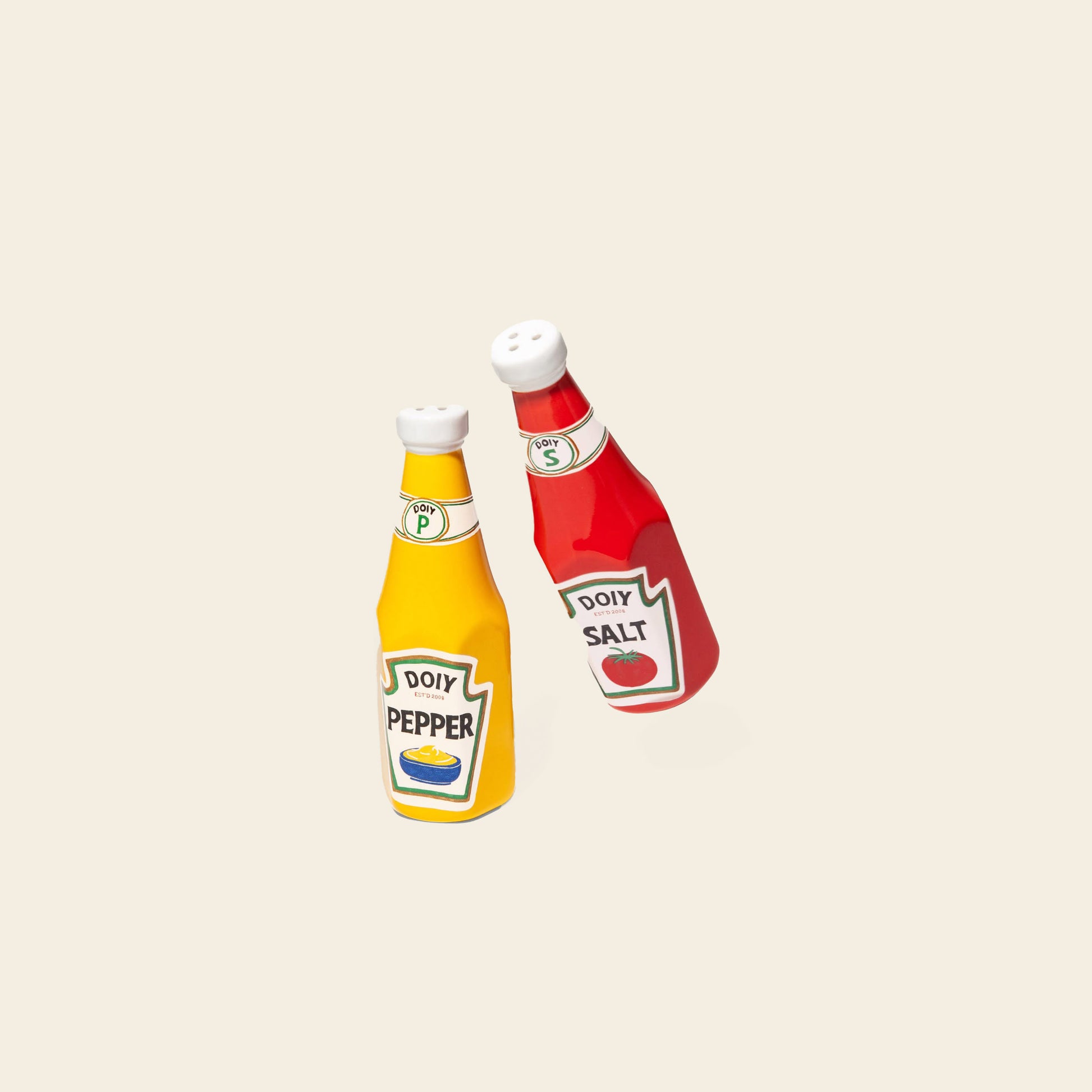 Add retro flair to your table with the DOIY Corner Shop Ketchup & Mustard Salt & Pepper Set—ceramic shakers shaped like classic bottles, featuring playful vintage-inspired labels by DOIY.