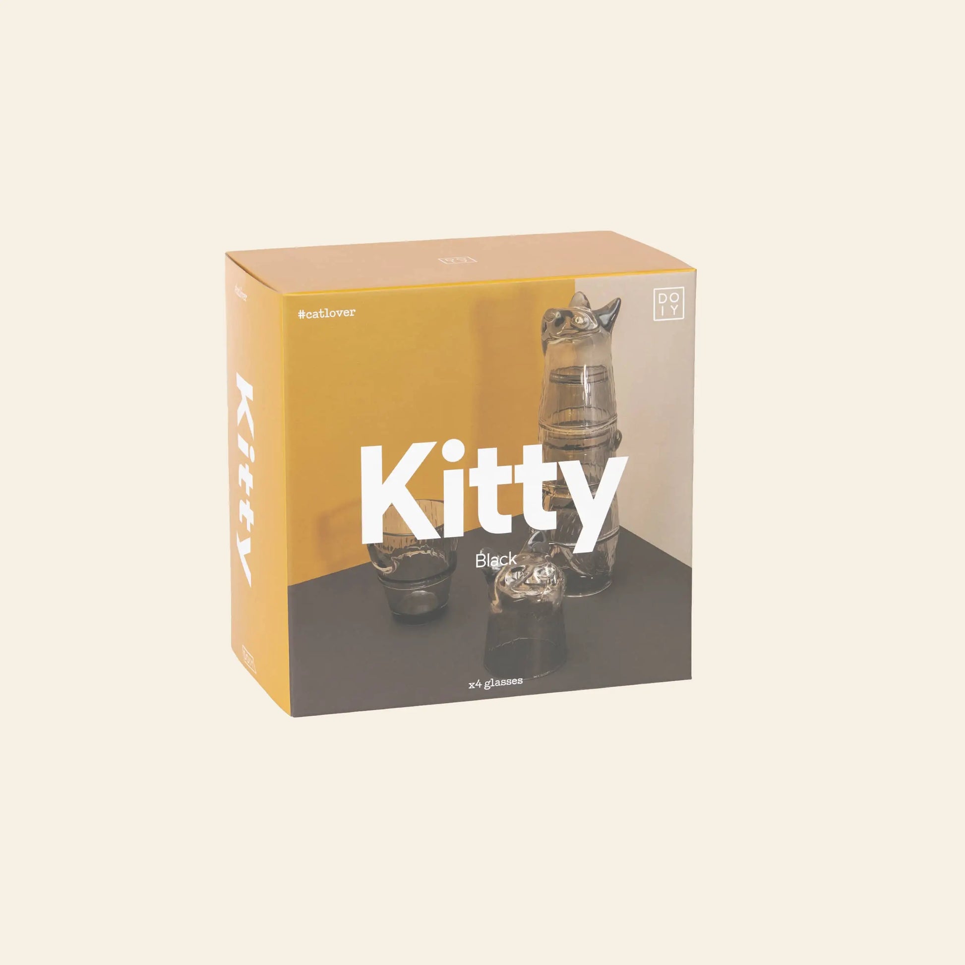A box of DOIY Kitty Glasses, Set of 4, features stackable black cat-shaped glasses visible through the packaging. The package displays Kitty in large white text on a yellow and beige background and is branded by DOIY.