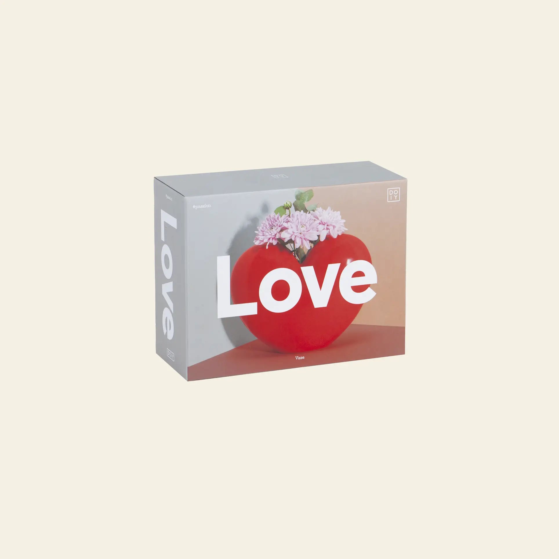 The DOIY Love Vase puzzle box by DOIY features a red heart-shaped vase with pink flowers and Love in bold white letters, set against a light beige background for a sentimental touch.