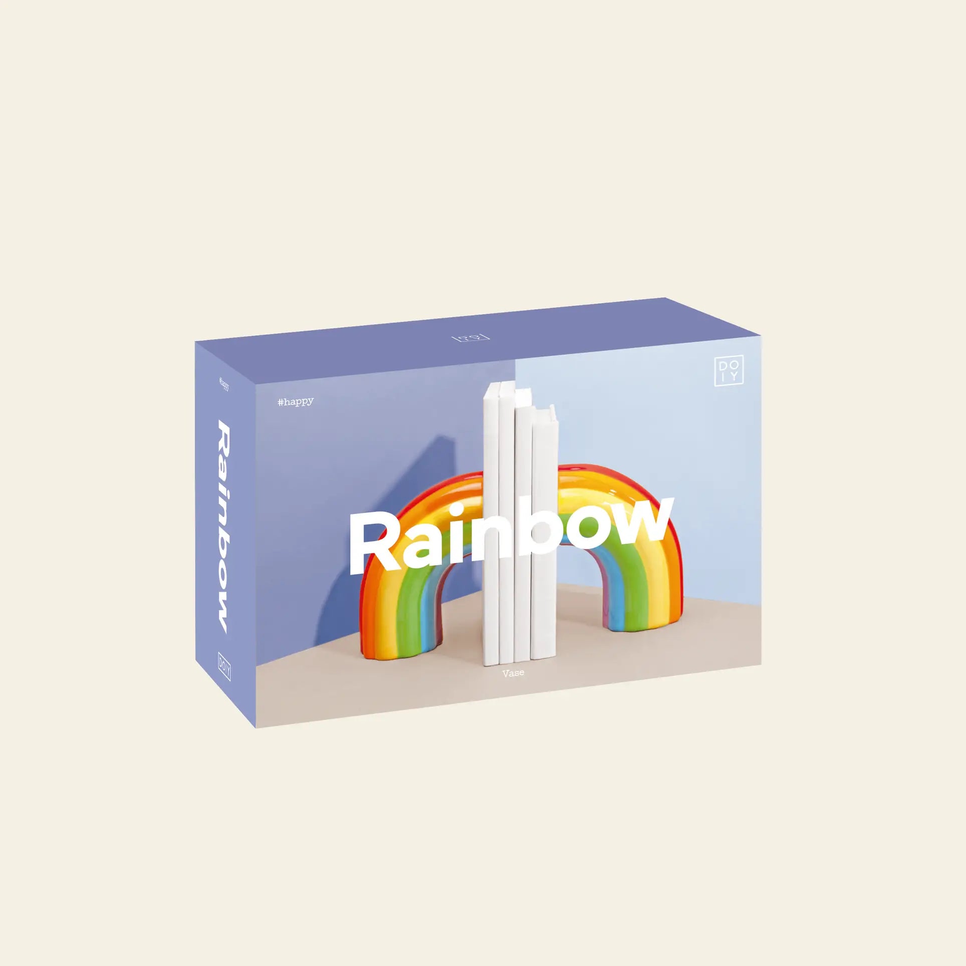 The DOIY Rainbow Bookend features a pastel box with vibrant colors, a 3D rainbow arch, and three upright white books. Rainbow appears on the packaging, highlighting DOIYs bookend as stylish home decor.