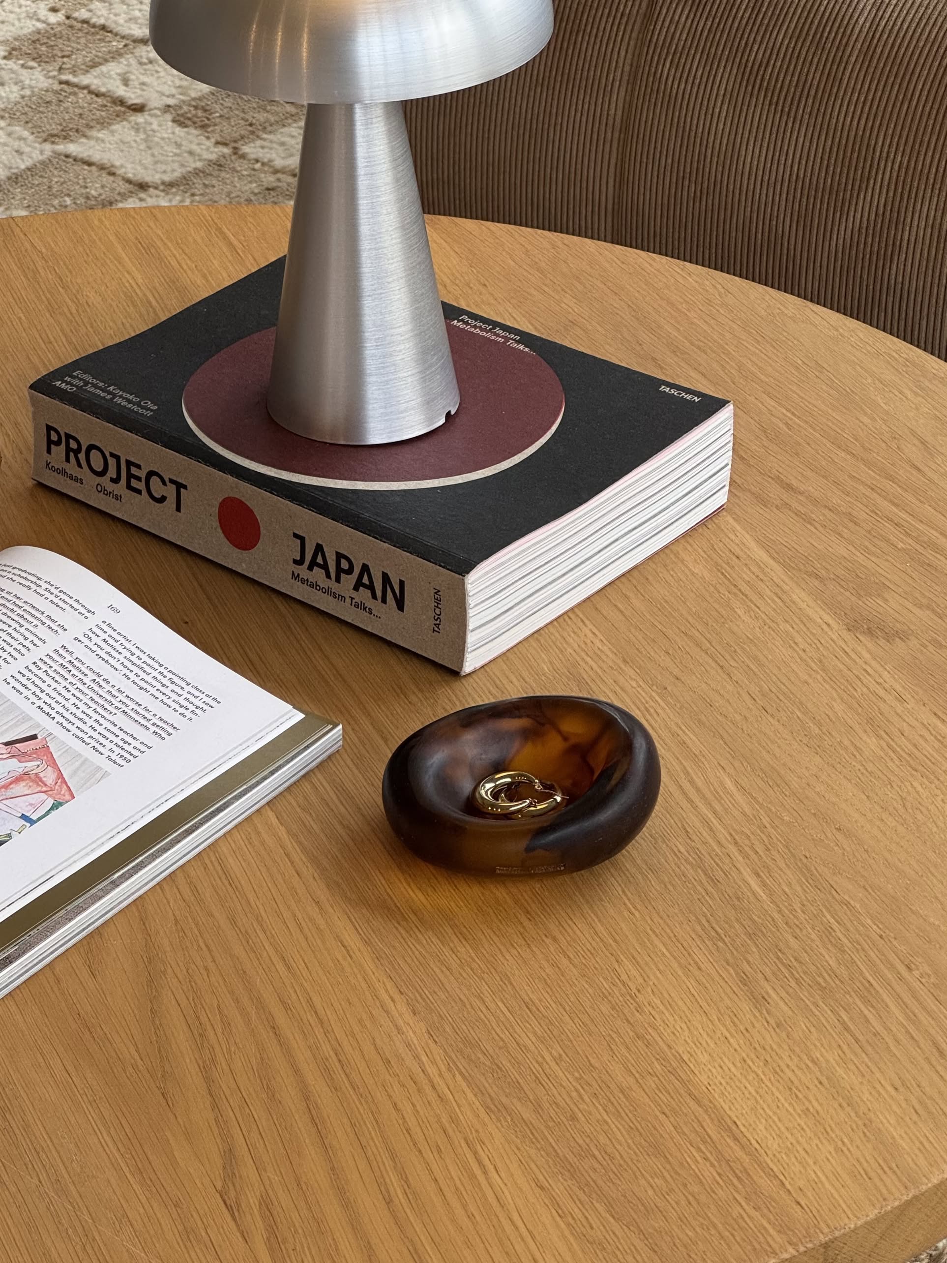 The Dinosaur Designs Small Drift Dish by Dinosaur Designs, with its chunky, translucent amber resin form, is showcased on a plain beige background and radiates an organic presence.