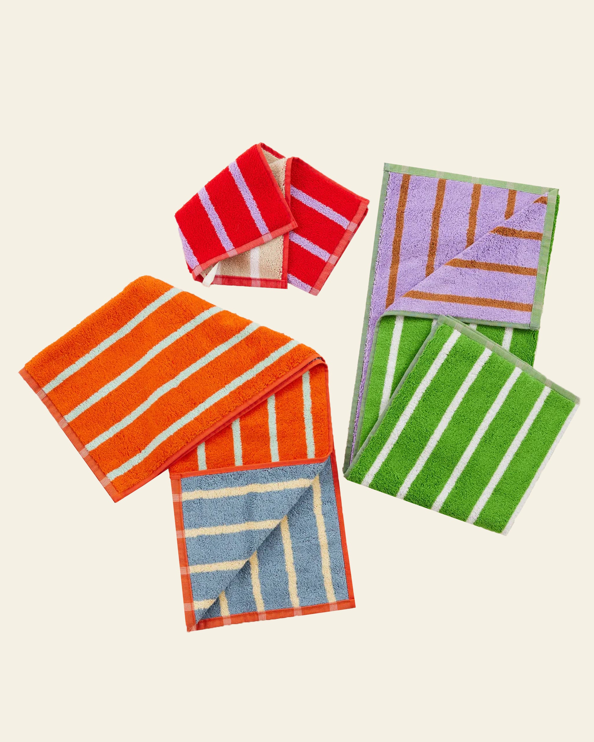 Bright, absorbent Dusen Dusen House Stripe Glass Hand Towels add a vibrant touch with horizontal stripes in orange, blue, red, purple, and green. Some are folded to show both sides—combining style and function by Dusen Dusen.