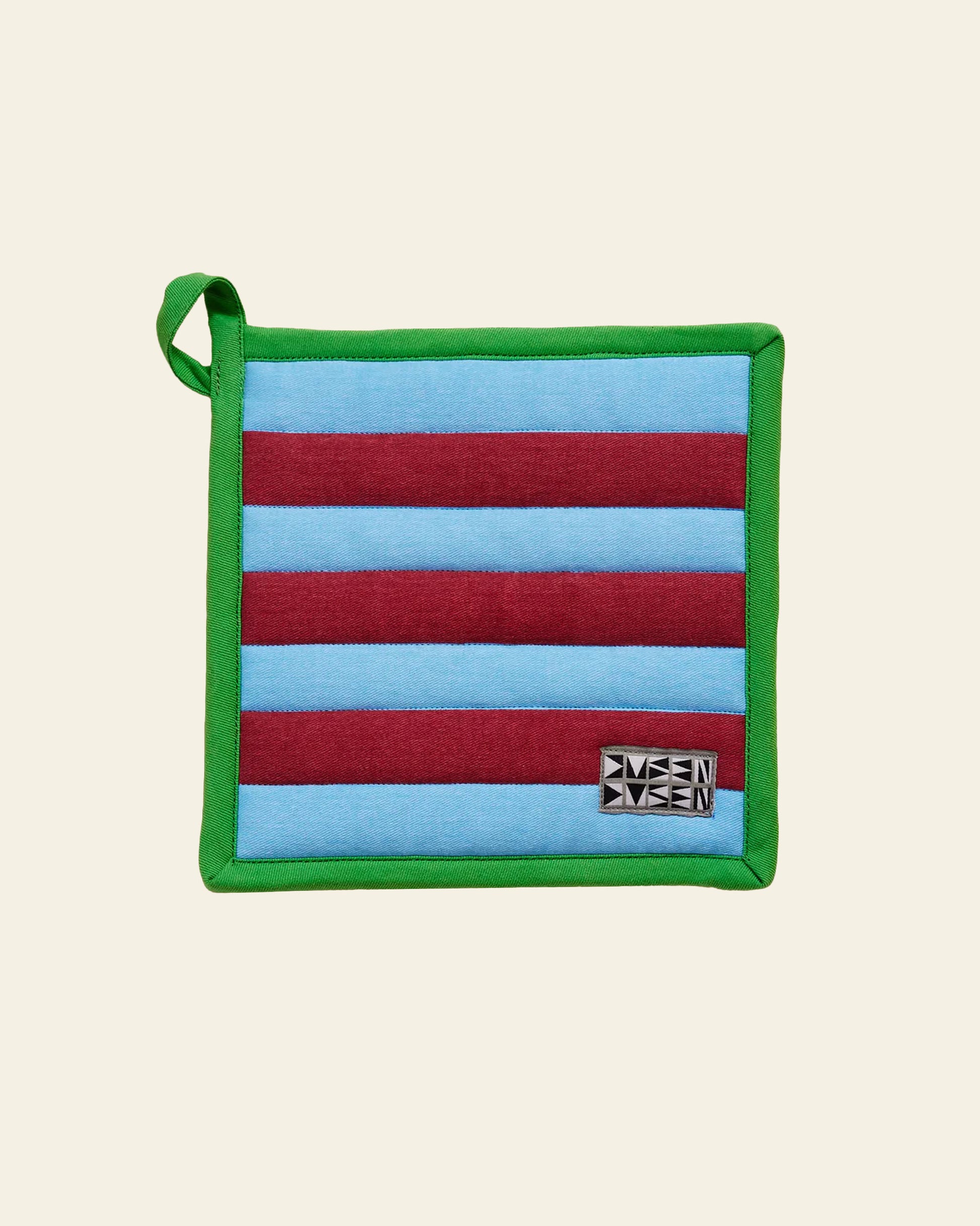 The Dusen Dusen Pocket Pot Holder by Dusen Dusen is a heat resistant rectangular kitchen accessory with maroon and light blue horizontal stripes, green trim, a small top left loop, and a black and white geometric label on the bottom right.