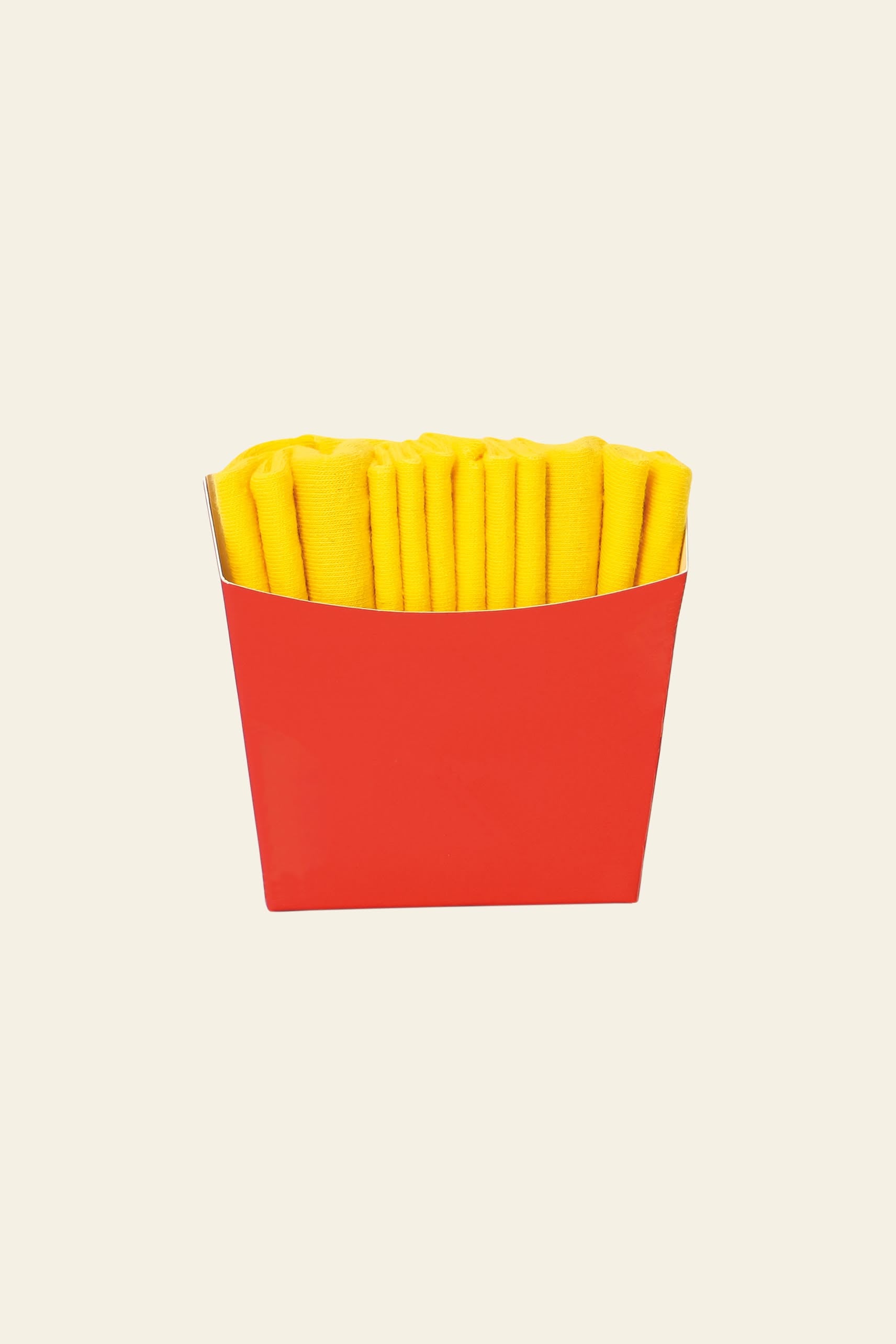Eat My Socks French Fries Socks by Eat My Socks come in a red paper container, with yellow socks rolled to look like real fries—unique accessories that stand out against a plain, light background.