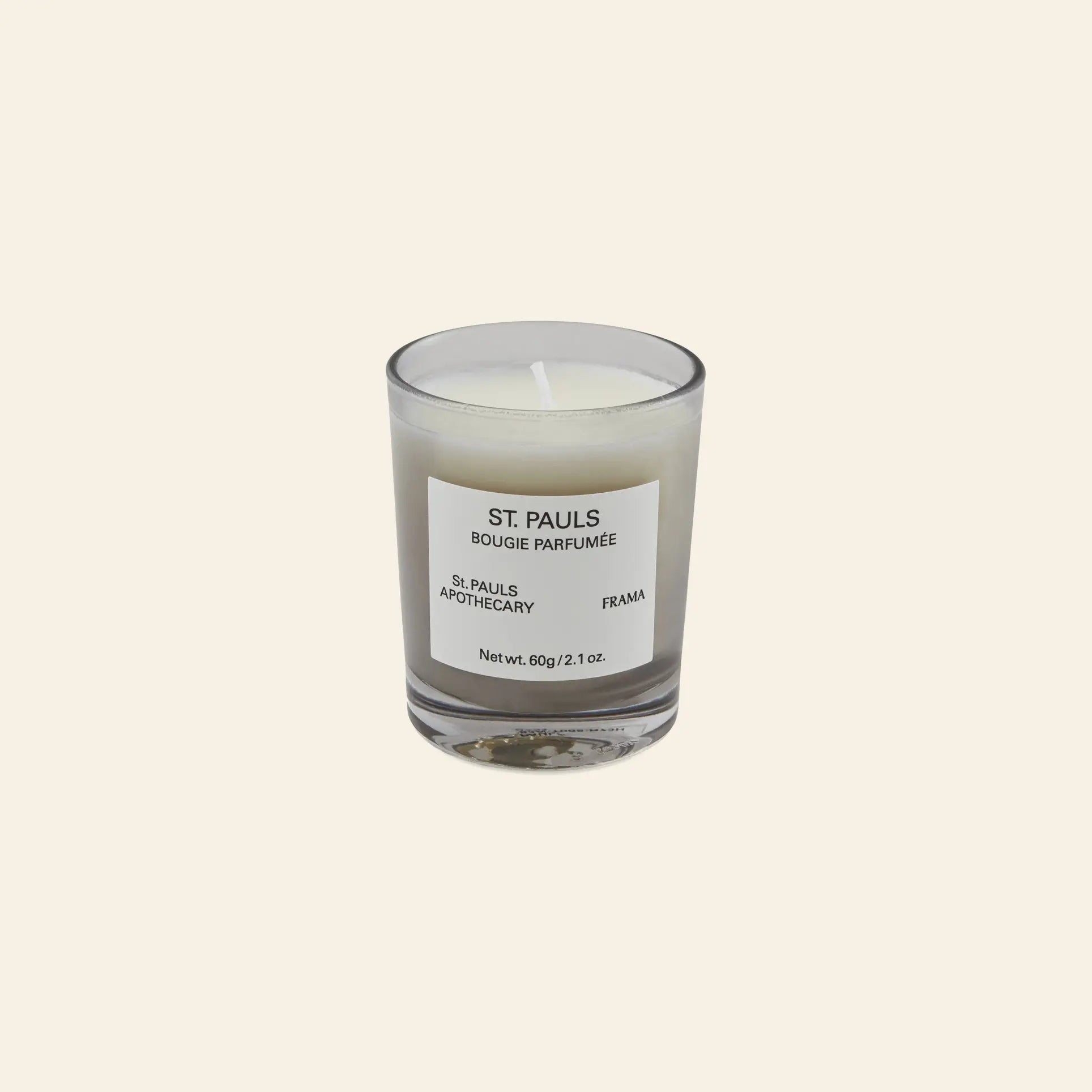 The FRAMA St. Pauls Scented Candle, 60g, features a minimalist label on clear glass. Part of the Apothecary Collection, its distinctive aroma brings sophistication and elegance to any room.