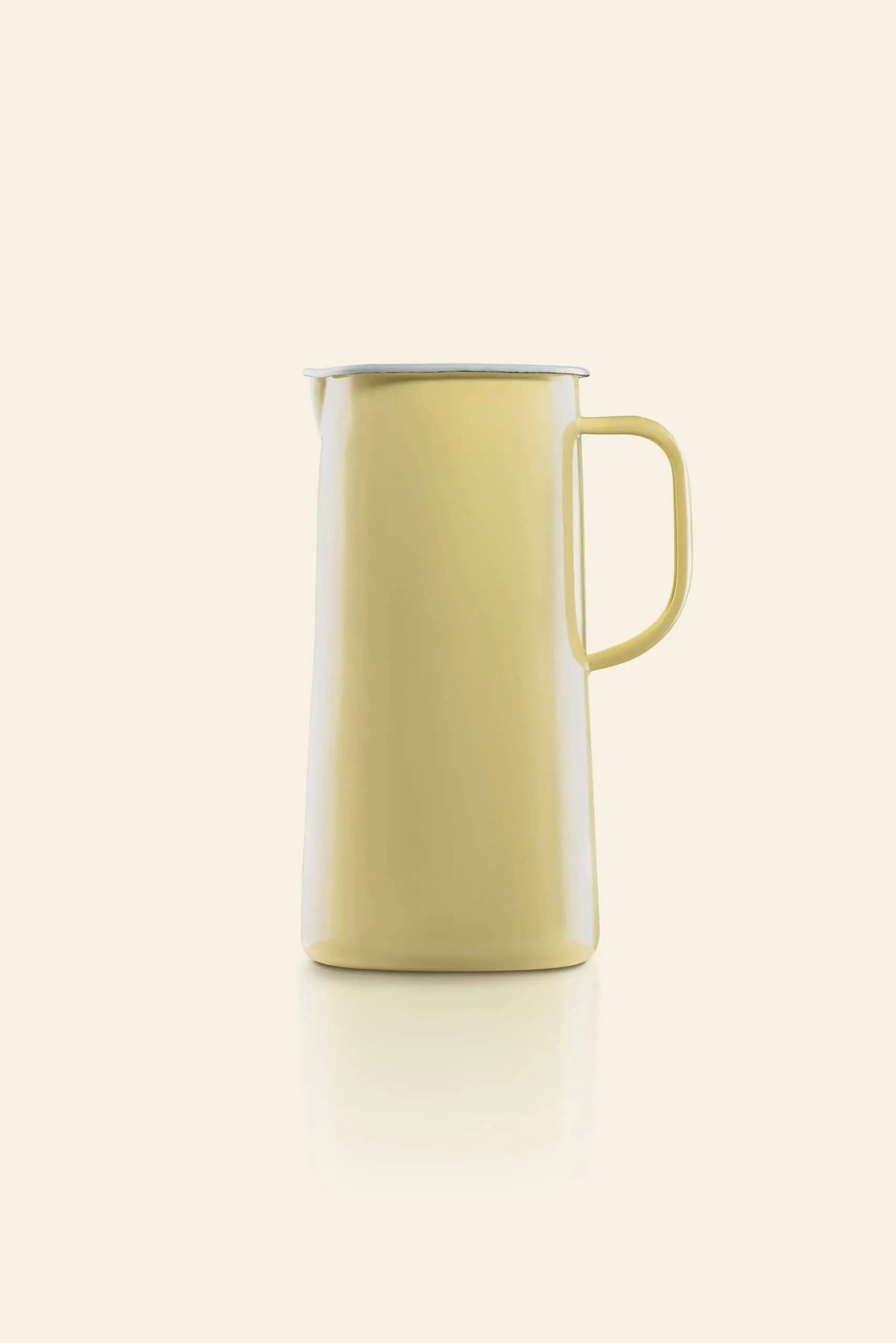 The Falcon Enamelware 3 Pint Jug by Falcon Enamelware is a tall, pale yellow enamel jug with a handle and spout, retro-inspired design, shown against a plain beige background.