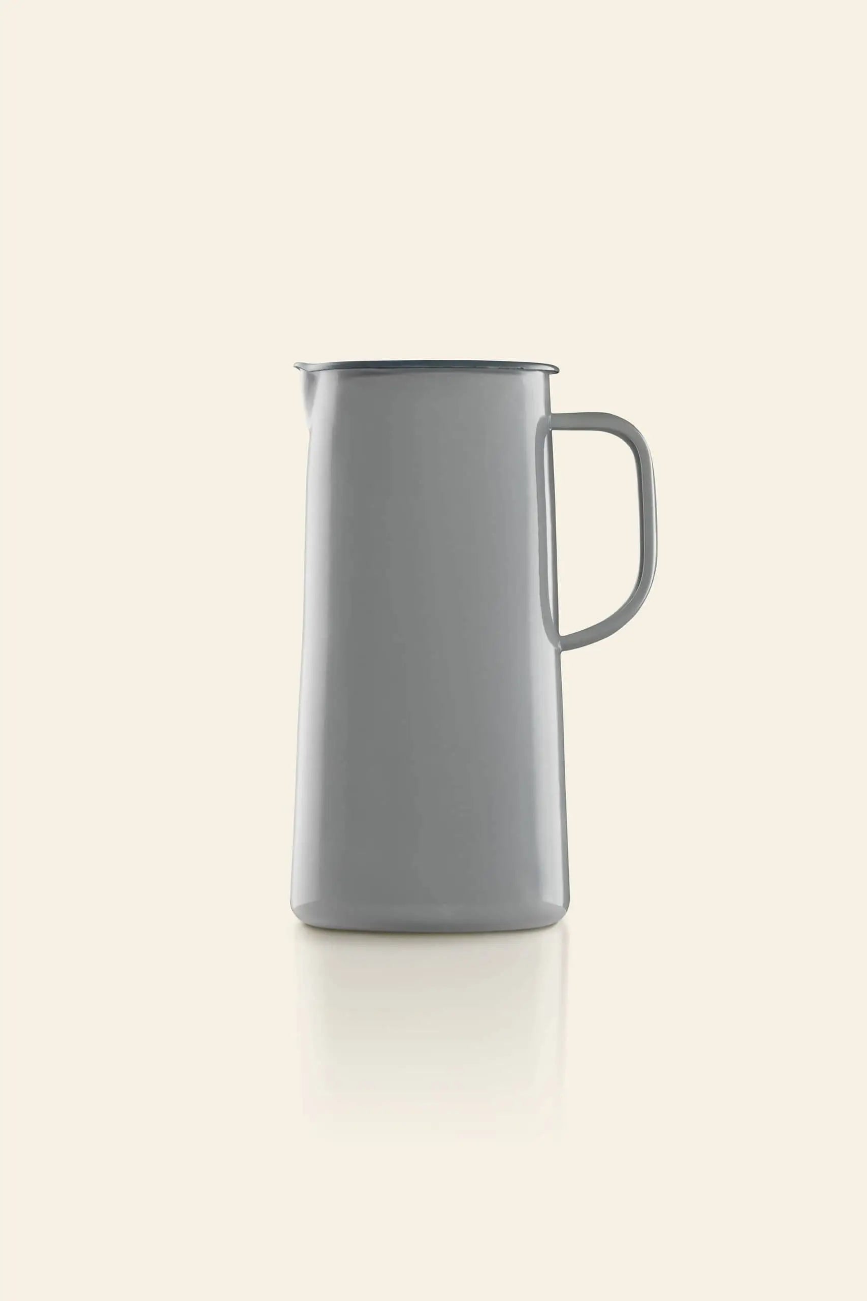 The Falcon Enamelware 3 Pint Jug features a minimalist gray enamel finish and handle, shown on a plain beige background. Its retro-inspired design by Falcon Enamelware brings timeless style to any setting.