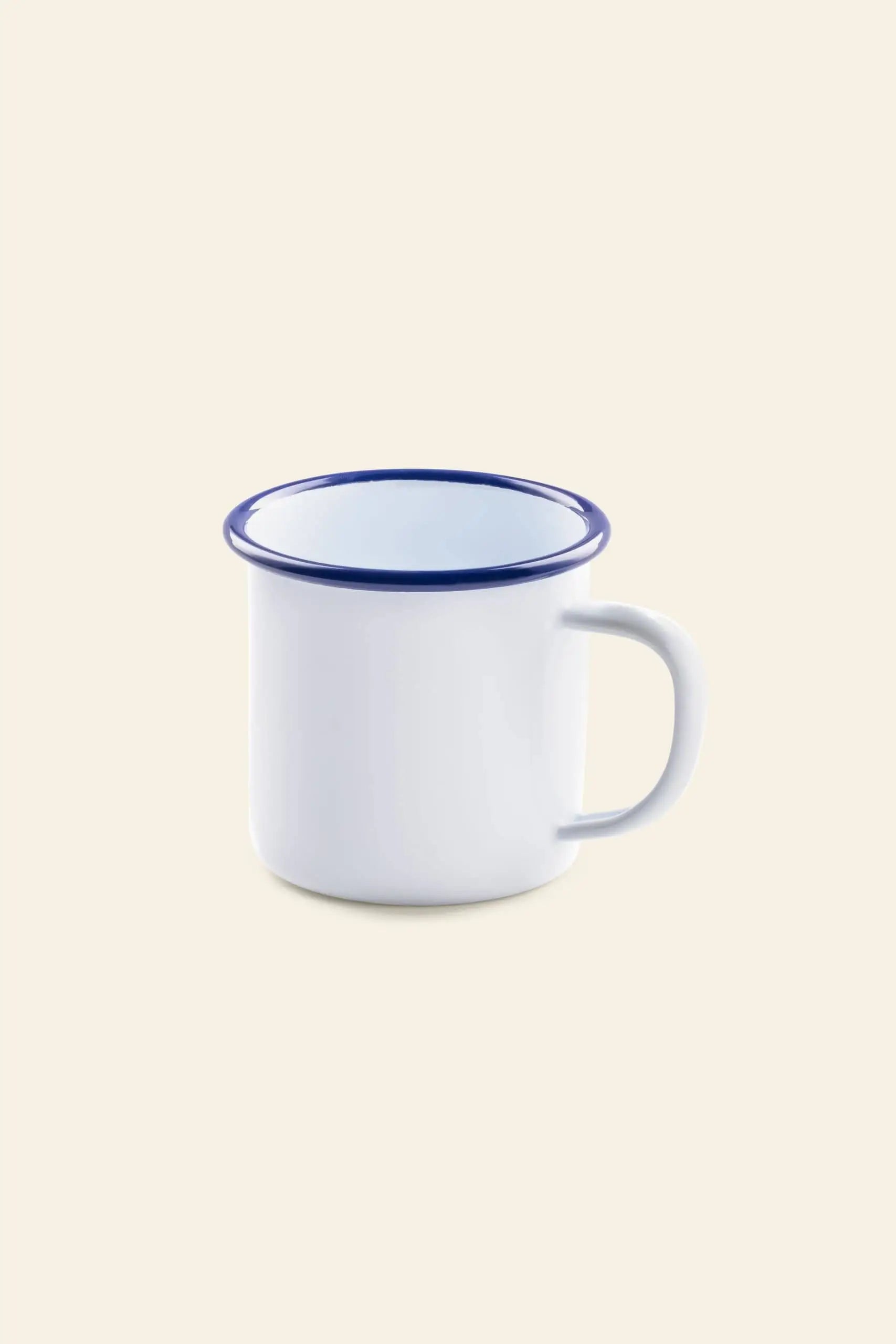 The Falcon Enamelware Mug by Falcon Enamelware features a vintage white enamel finish with a blue rim and handle, displayed on a light beige background.