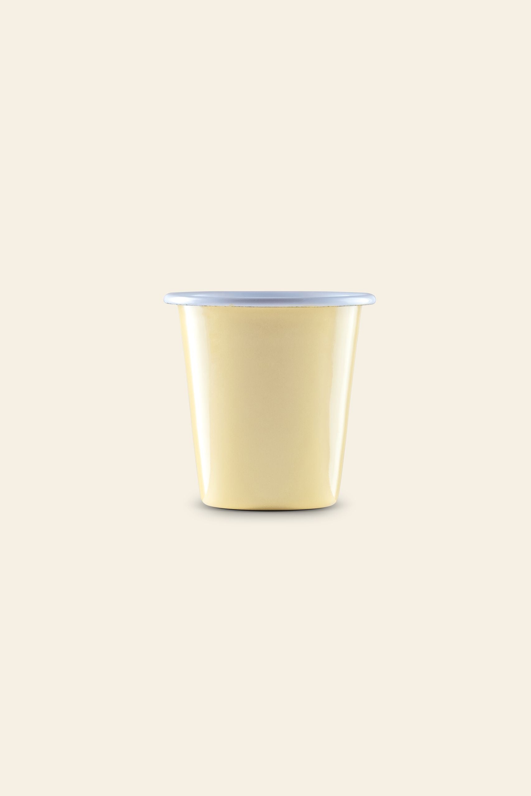 A small, yellow Falcon Enamelware Tumbler by Falcon Enamelware, with a simple form inspired by vintage enamelware, sits against a plain beige background.