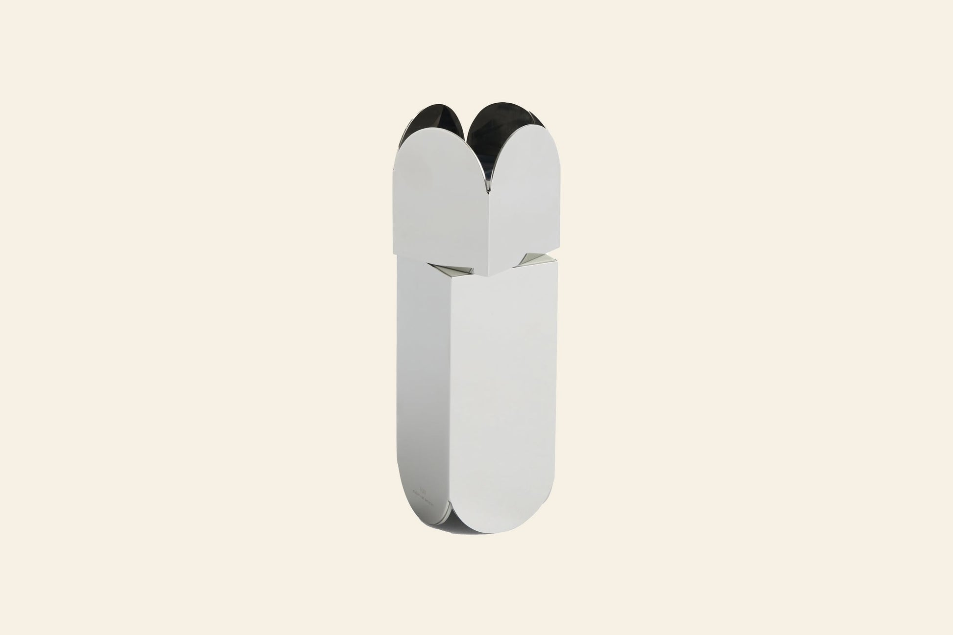 The HAY Arcs Salt & Pepper Grinder by HAY is a minimalist, stainless steel cylinder with rounded edges and four petal-like sections at the top, shown upright against a plain, light beige background—ideal for modern kitchens.