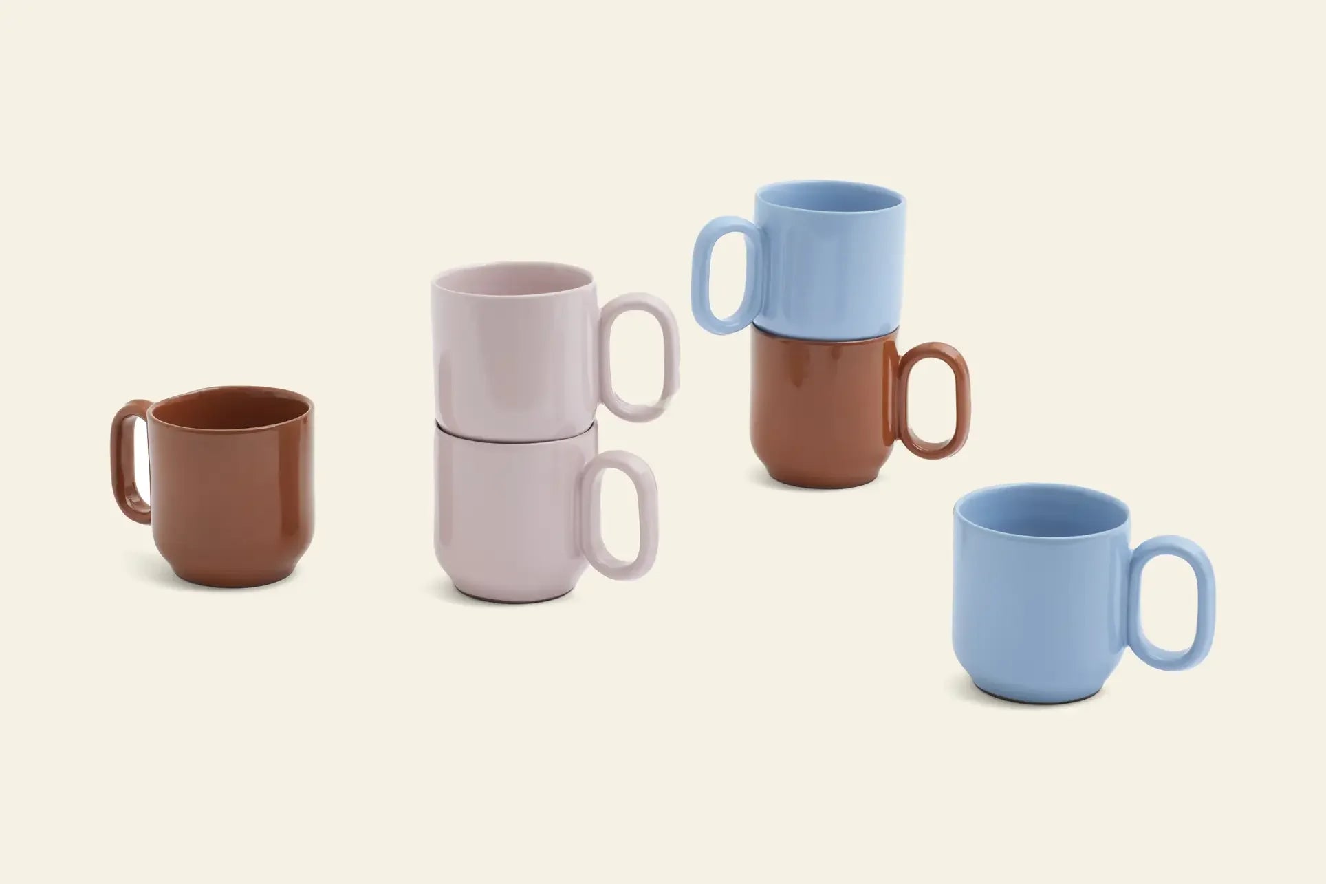 Five HAY Barro Cups, Set of 2 by HAY, in brown, light pink, and blue are arranged on a cream background. Some cups are stacked in pairs, while others stand alone.