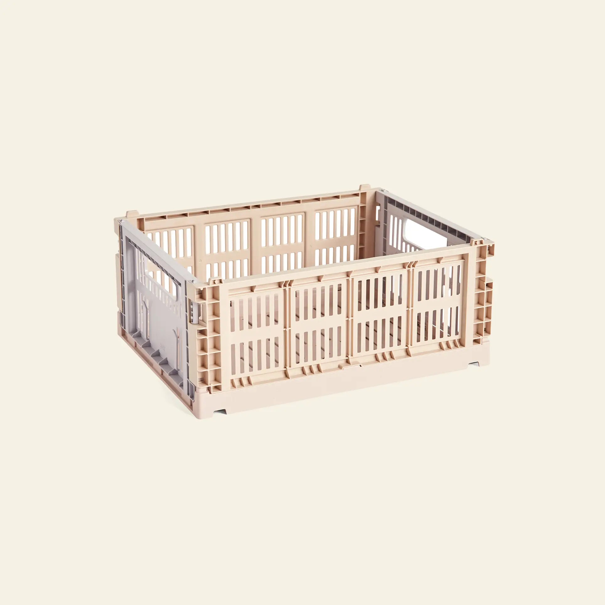 The HAY Colour Crate Mix Medium, a beige rectangular storage box made of recycled plastic with vented sides, is shown empty against a plain light background.