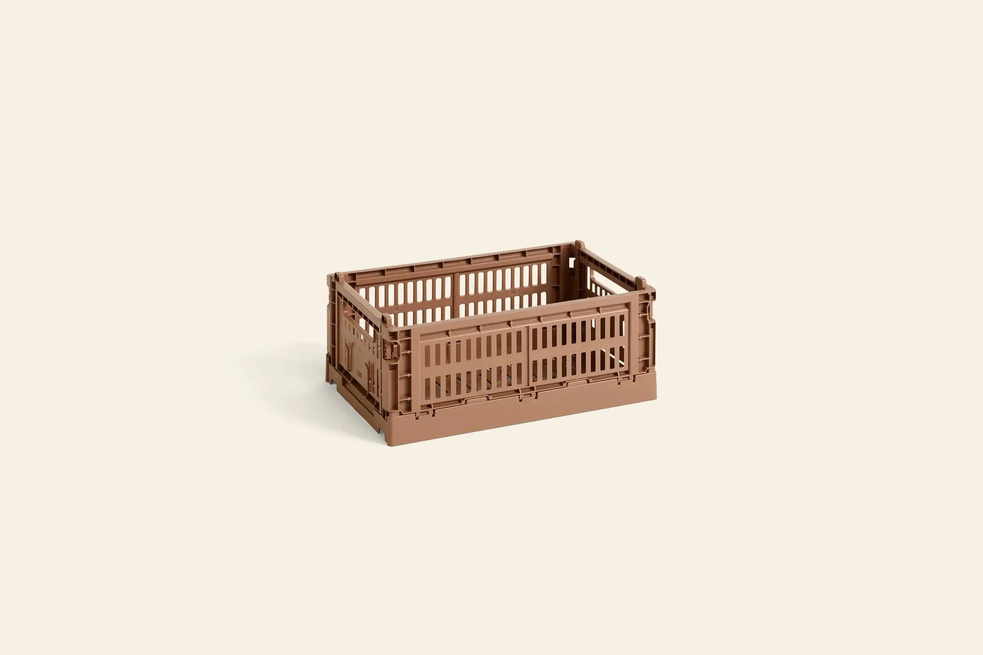 The HAY Colour Crate Small by HAY is a compact, brown rectangular storage box with slatted sides and a solid base—ideal for keeping your space organized with a touch of color.