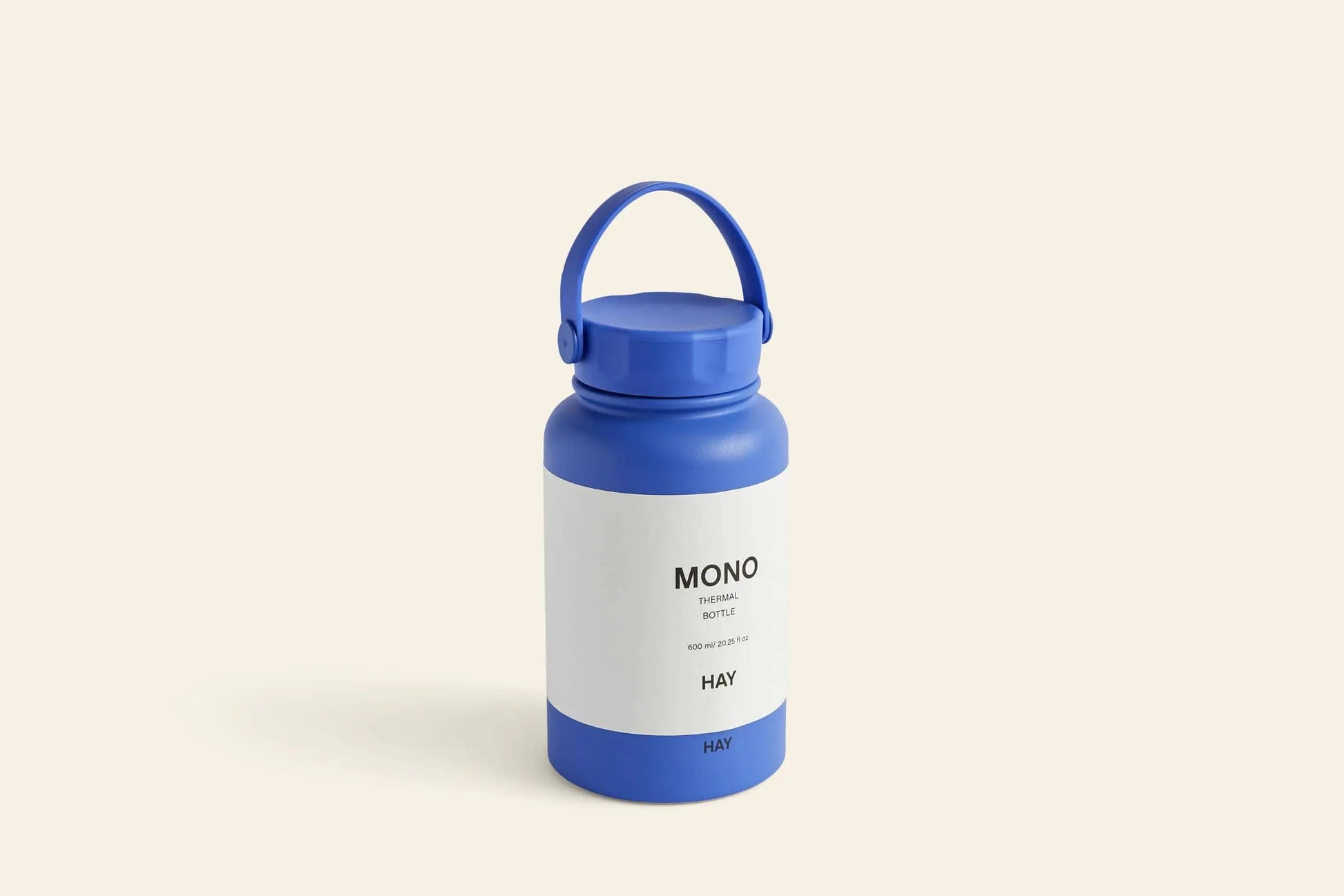 The HAY Mono Thermal Bottle by HAY is a stylish blue insulated bottle with a handle, featuring a white label reading MONO THERMAL BOTTLE and HAY, perfect for beverages and shown against a plain light background.