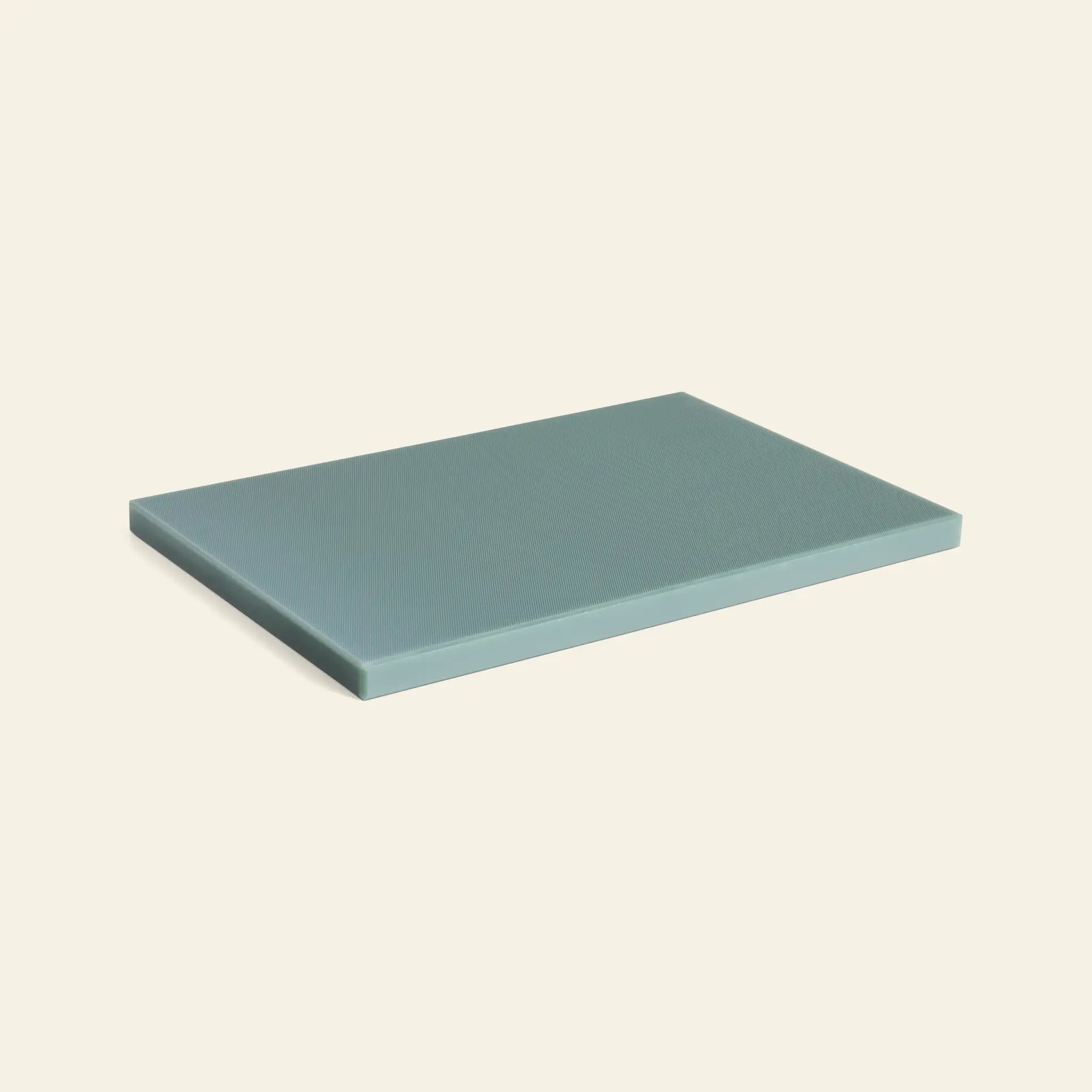 The HAY Slice Chopping Board L, a rectangular teal board by HAY, is displayed on a light beige background—perfect for any kitchen and designed to help prevent cross-contamination.