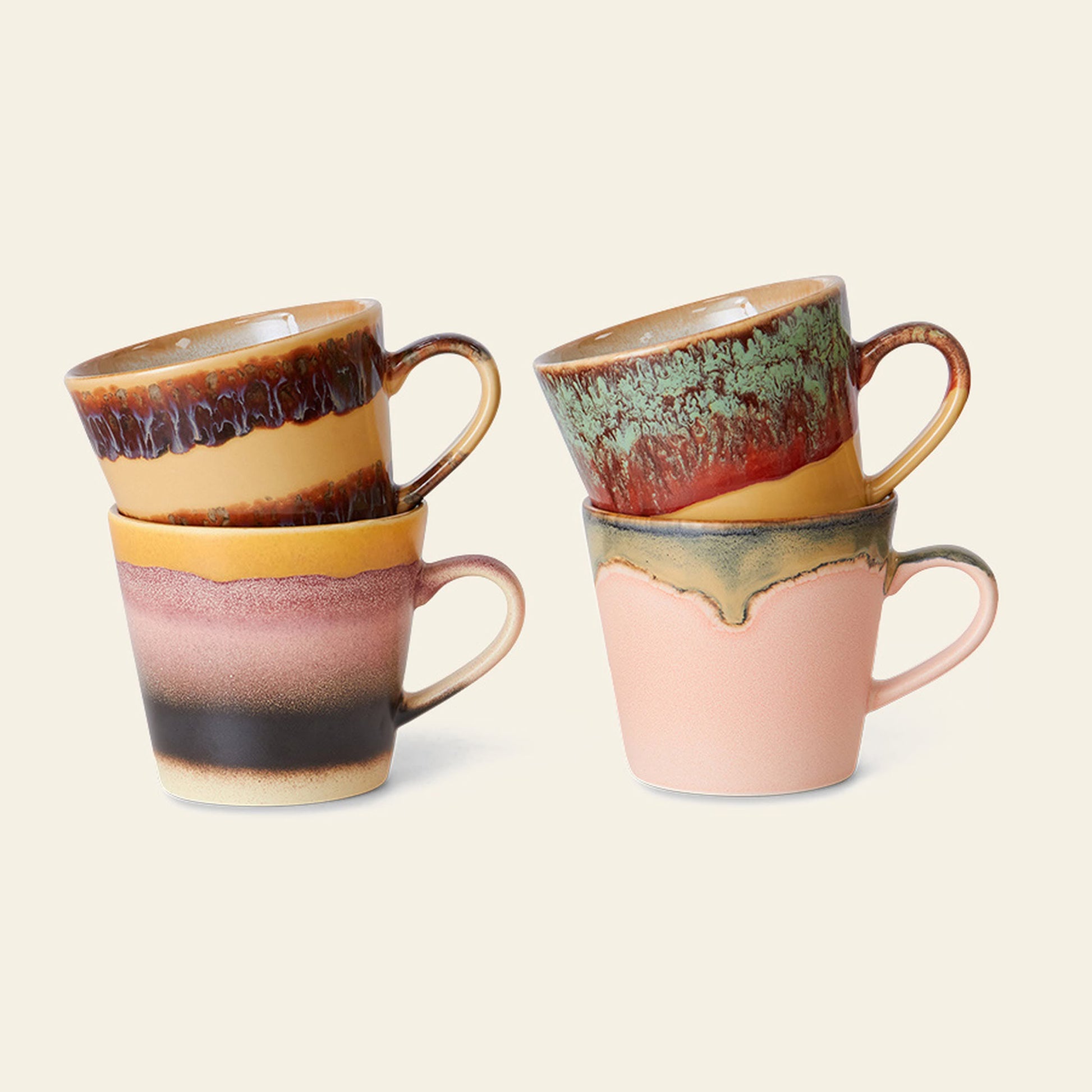 The HKliving 70s Ceramics Cappuccino Mugs Set of 4 showcases unique, colorful, and textured glazes in earthy tones and artistic patterns. The retro mugs are stacked in pairs against a plain light background.