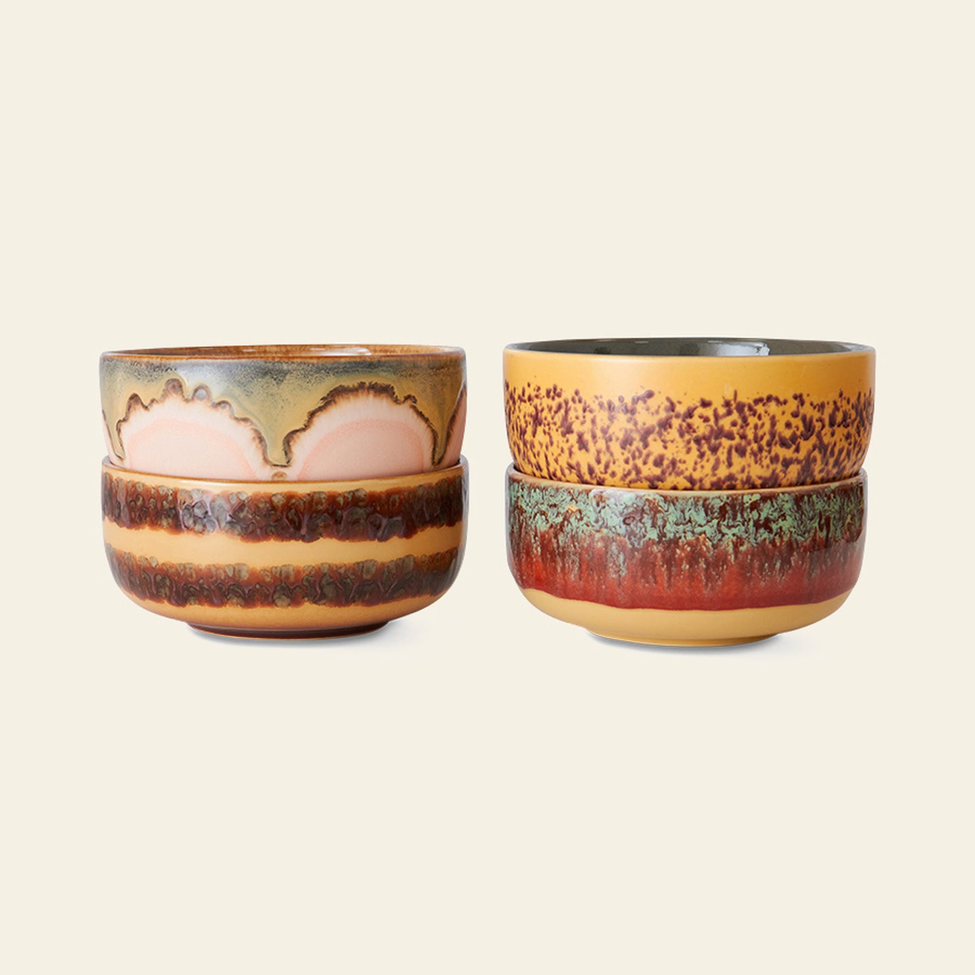 Two stacks of HKliving 70s Ceramics Dessert Bowls, Set of 4, featuring earthy tones and unique textured glazes, are displayed side by side on a light beige background. Each stack contains two bowls.