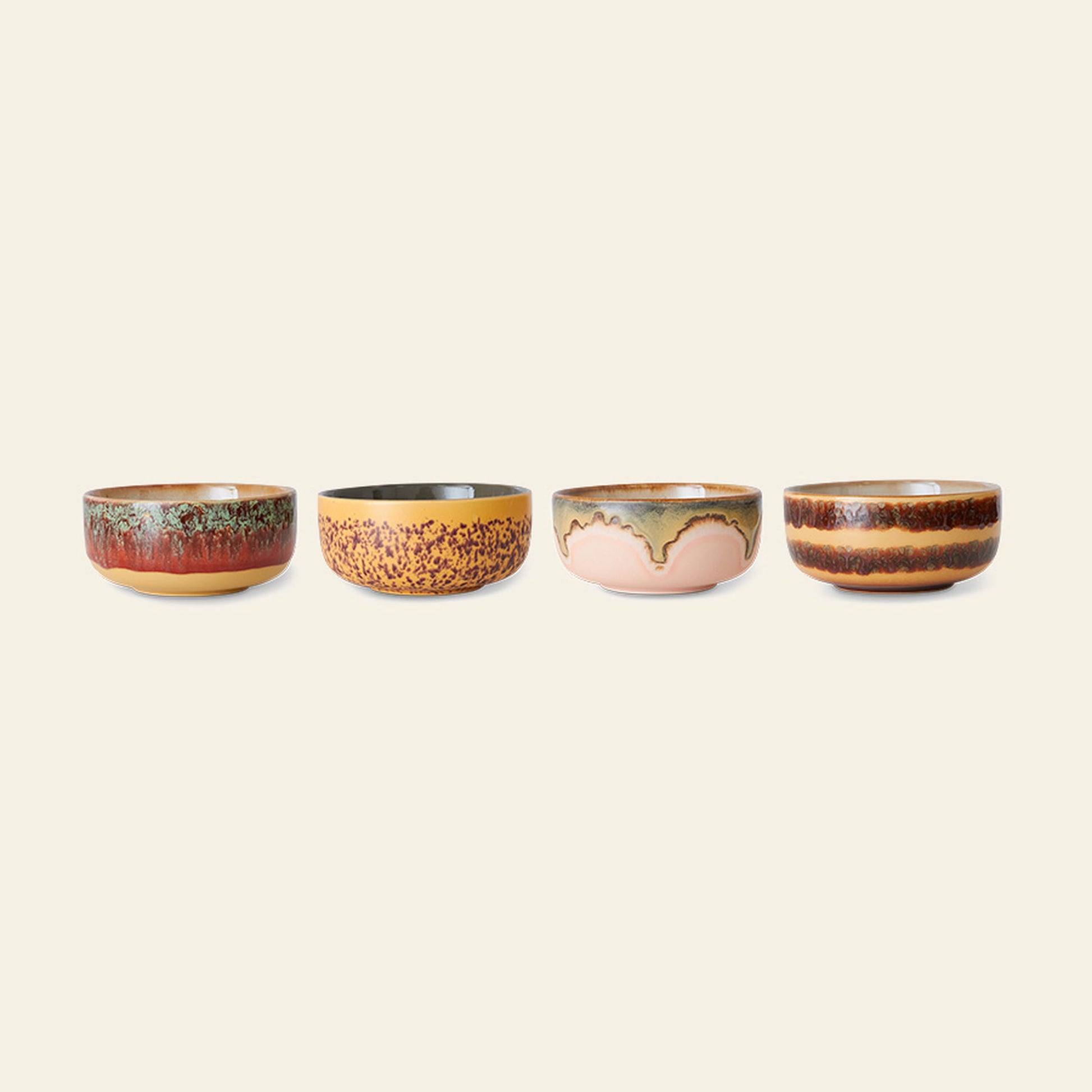 The HKliving 70s Ceramics Dessert Bowls Set of 4 features unique, earthy designs and retro-inspired color patterns, all beautifully arranged in a row against a plain light background.